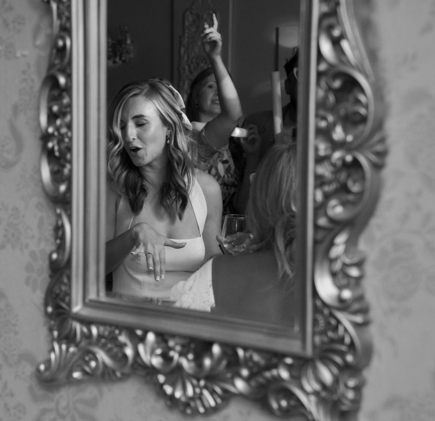 Black and white portraits in ornate frames capture wedding celebration moments.