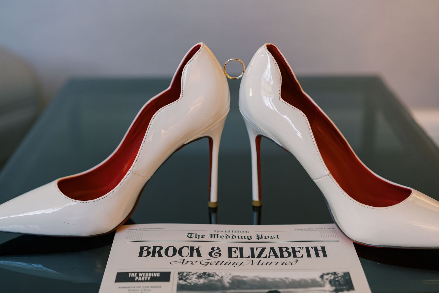 Elegant white patent leather wedding heels on printed wedding program.