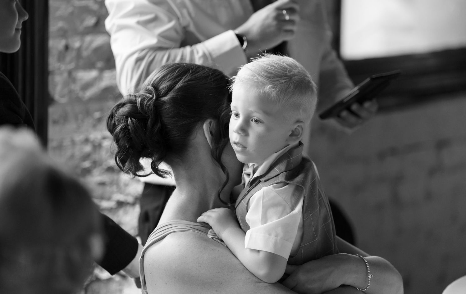 Black and white candid shots of wedding guests during a celebration.