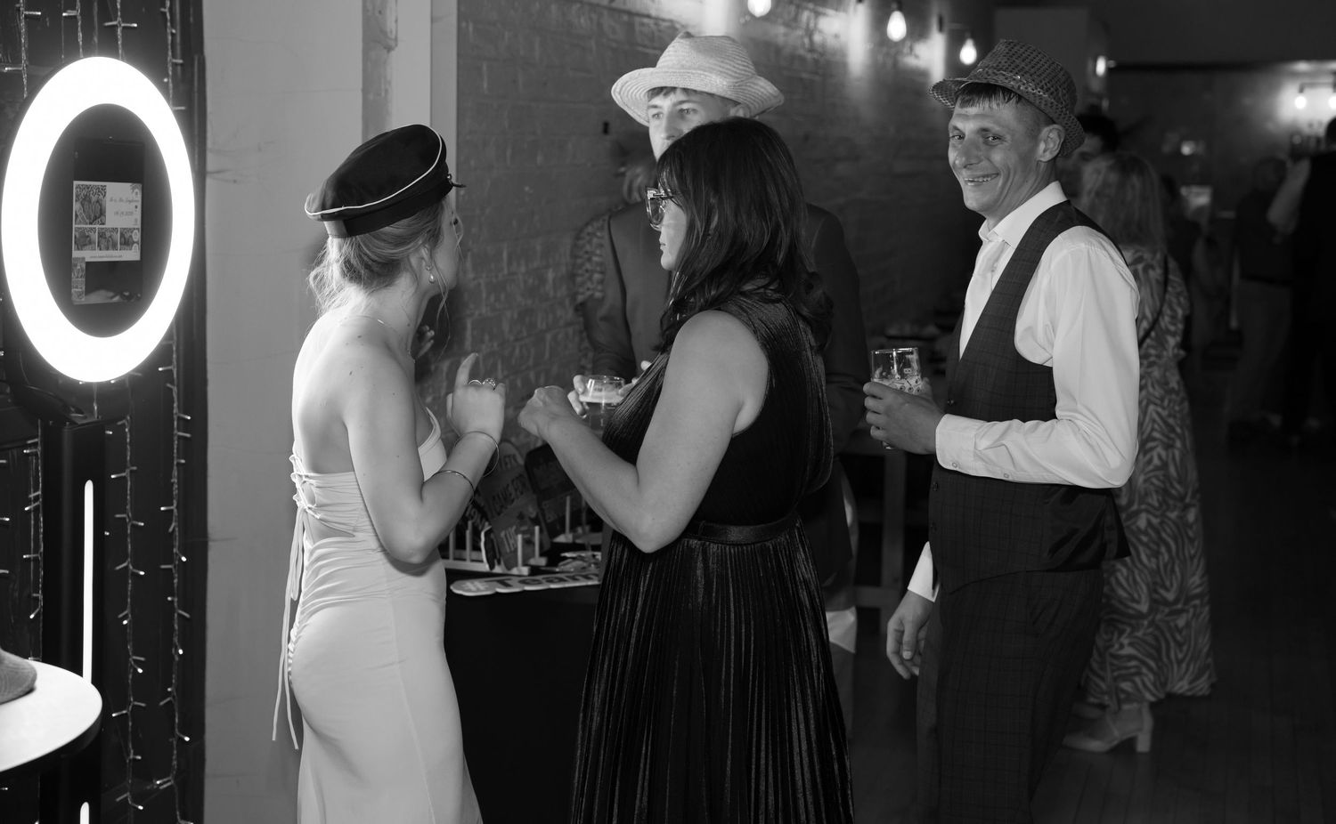 Black and white photos of people dancing and socializing at what appears to be a formal evening event.