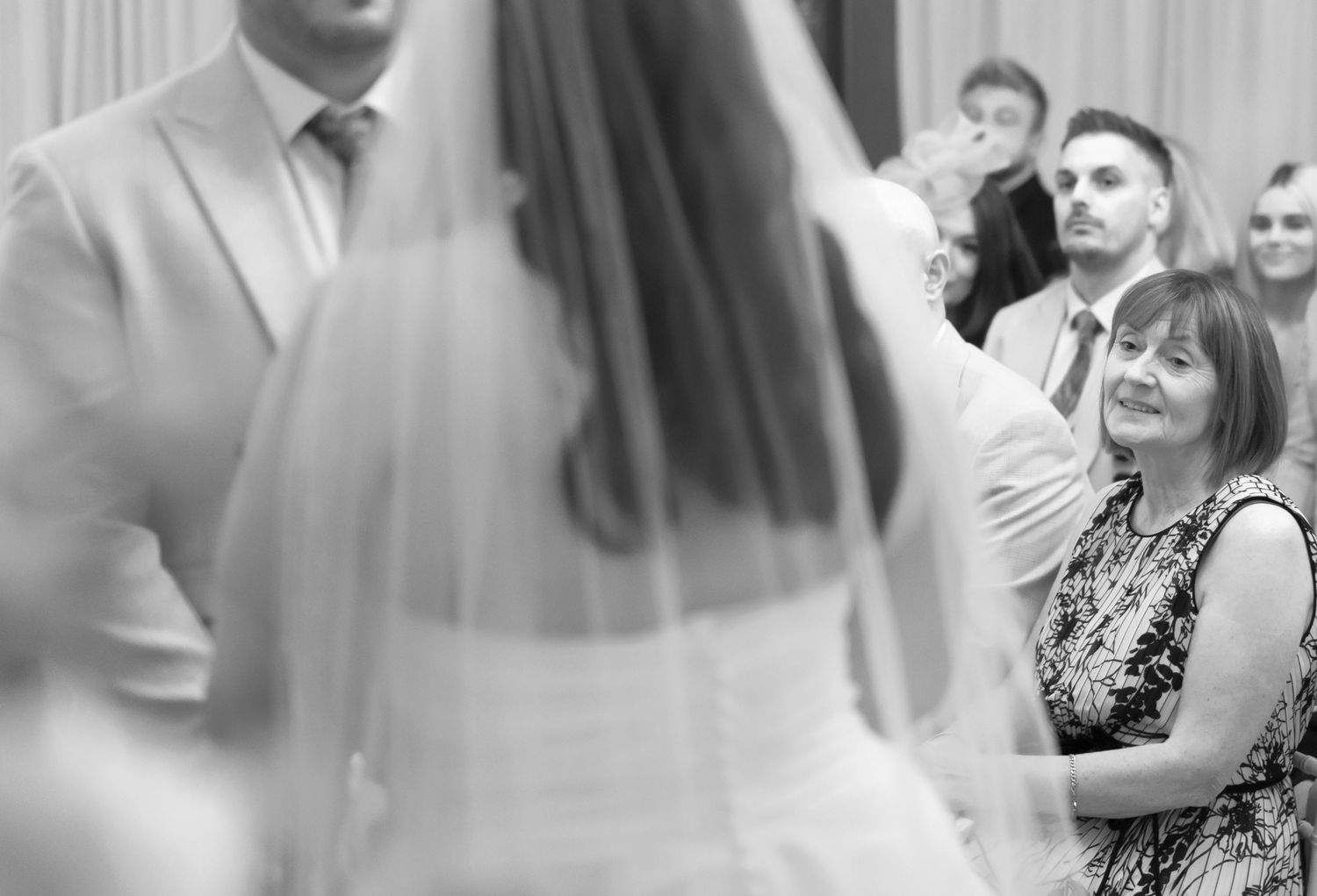 Black and white photo montage shows people dancing and celebrating at what appears to be a wedding reception.