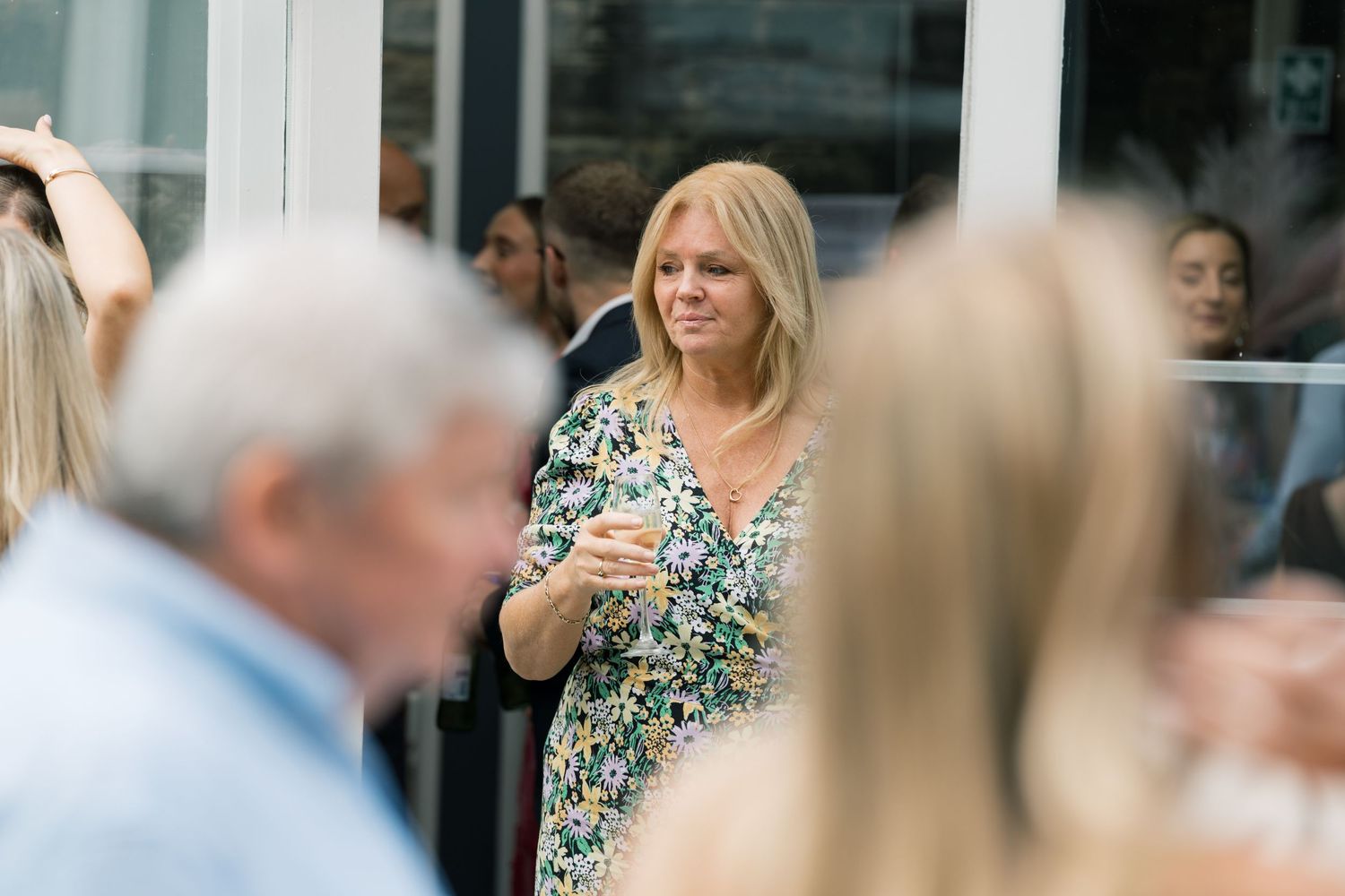 Candid moments of wedding guests mingling at an outdoor reception.