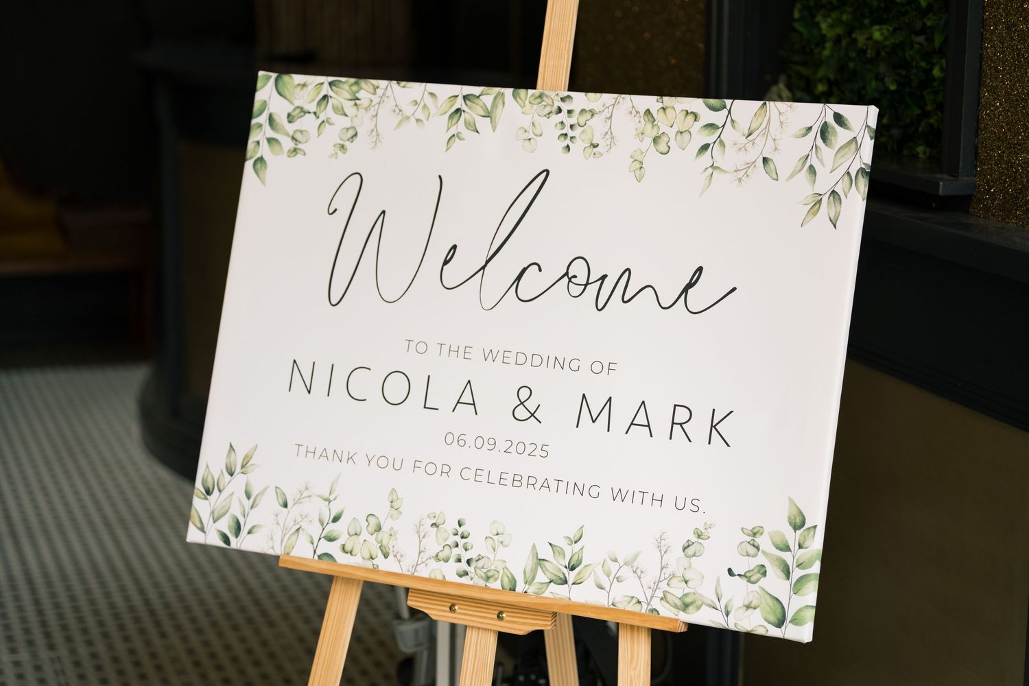Botanical-themed wedding reception cards featuring greenery designs and elegant calligraphy on white paper.