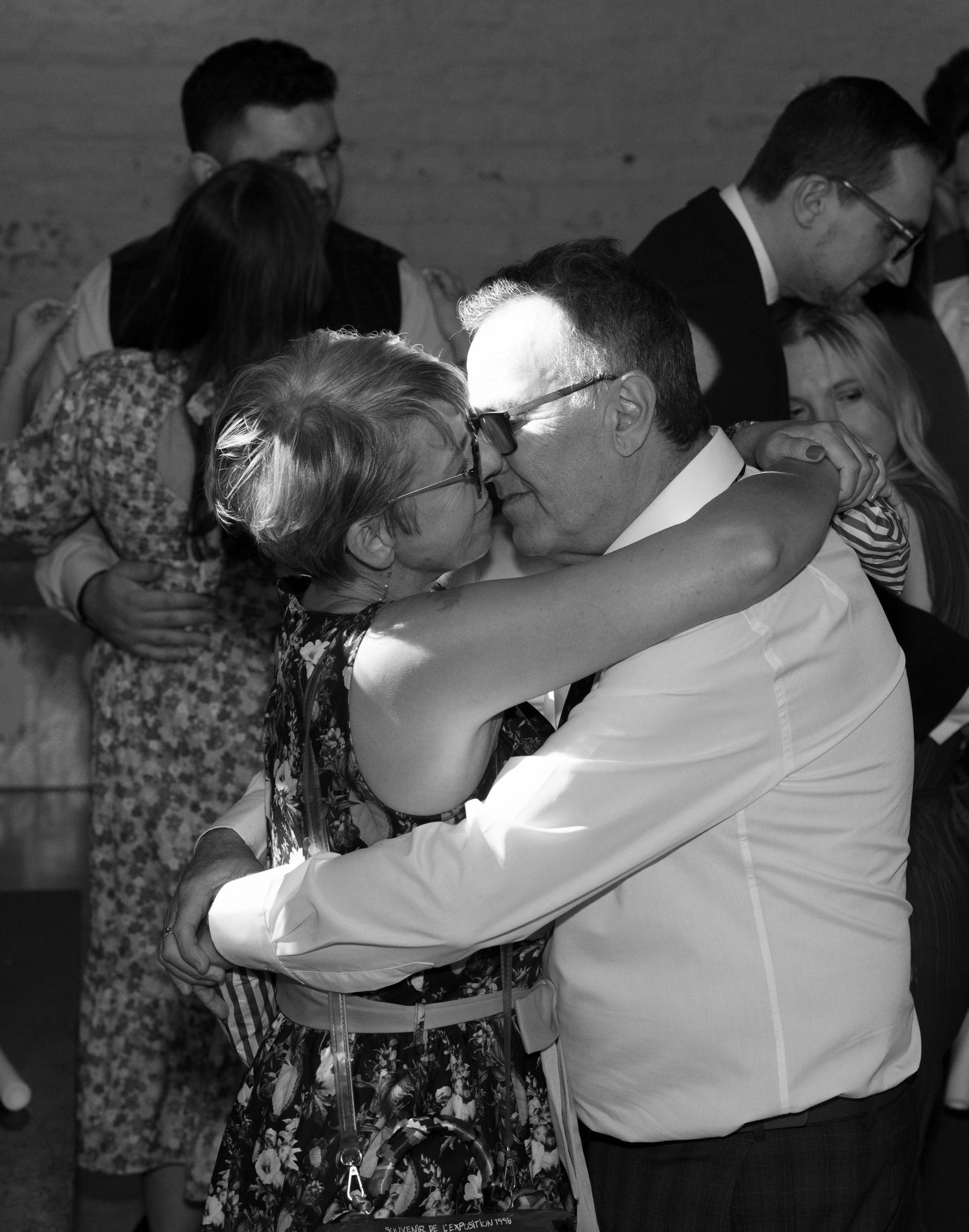 Black and white photos capture intimate dance moments at a wedding reception.