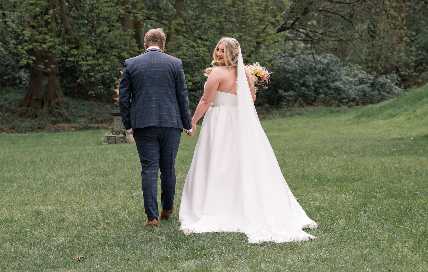 Bride and groom celebrating after their wedding ceremony at Whitley Hall, Sheffield.