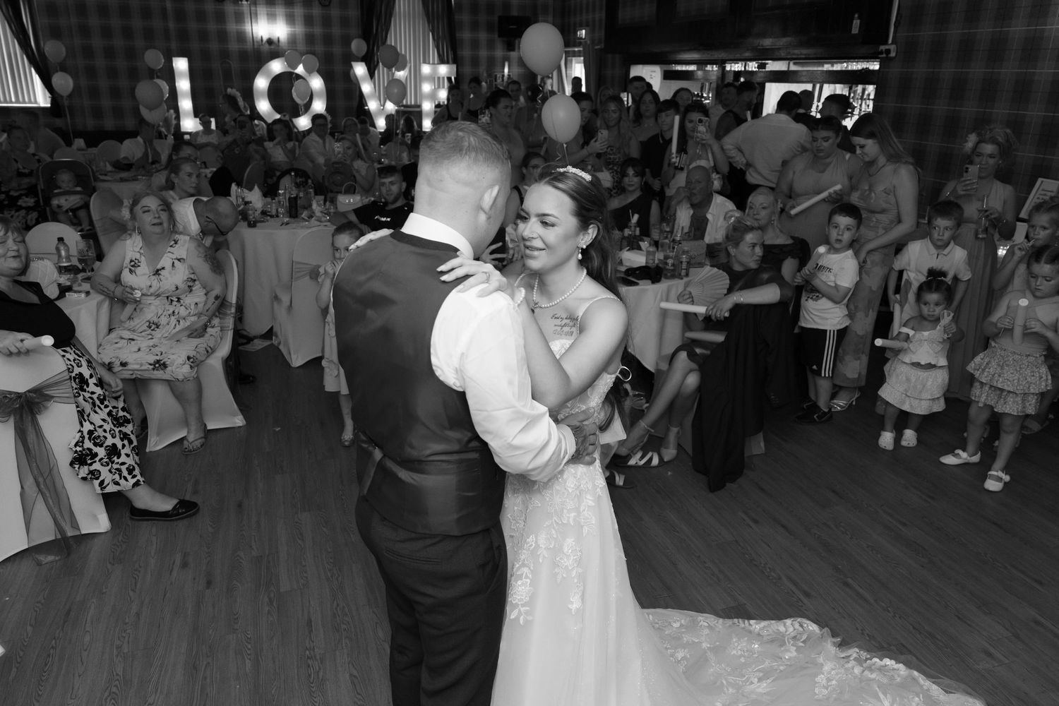 Four candid dance floor photos from a festive wedding reception show couples dancing together at a wedding celebration.