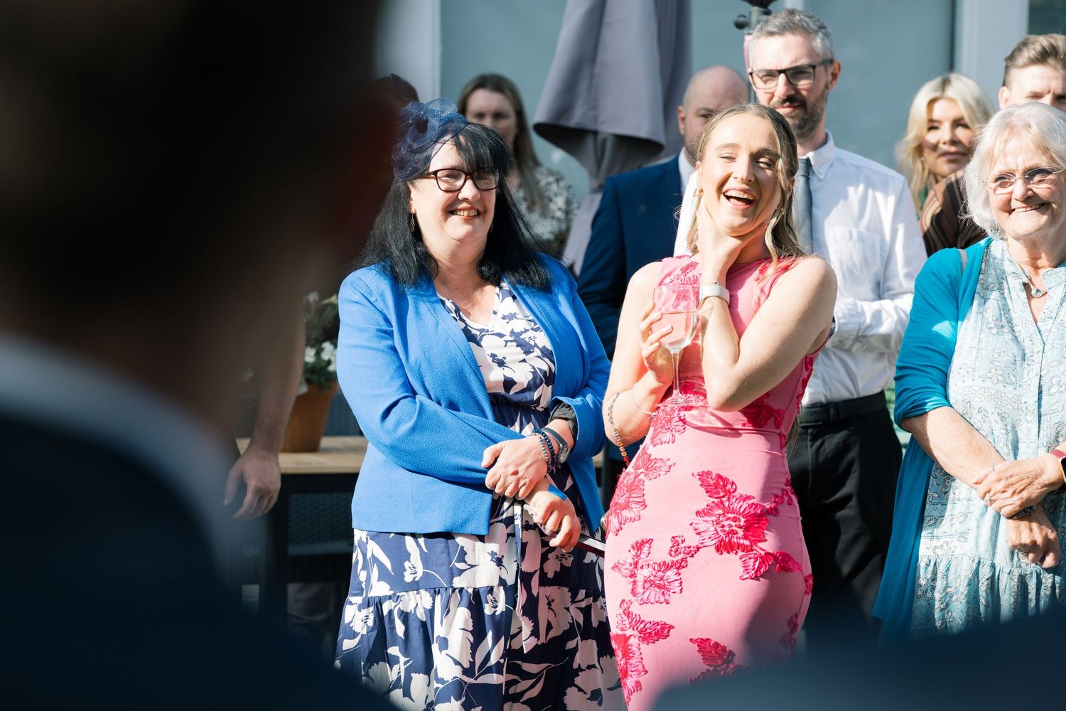 Wedding guests reacting emotionally during an outdoor ceremony.