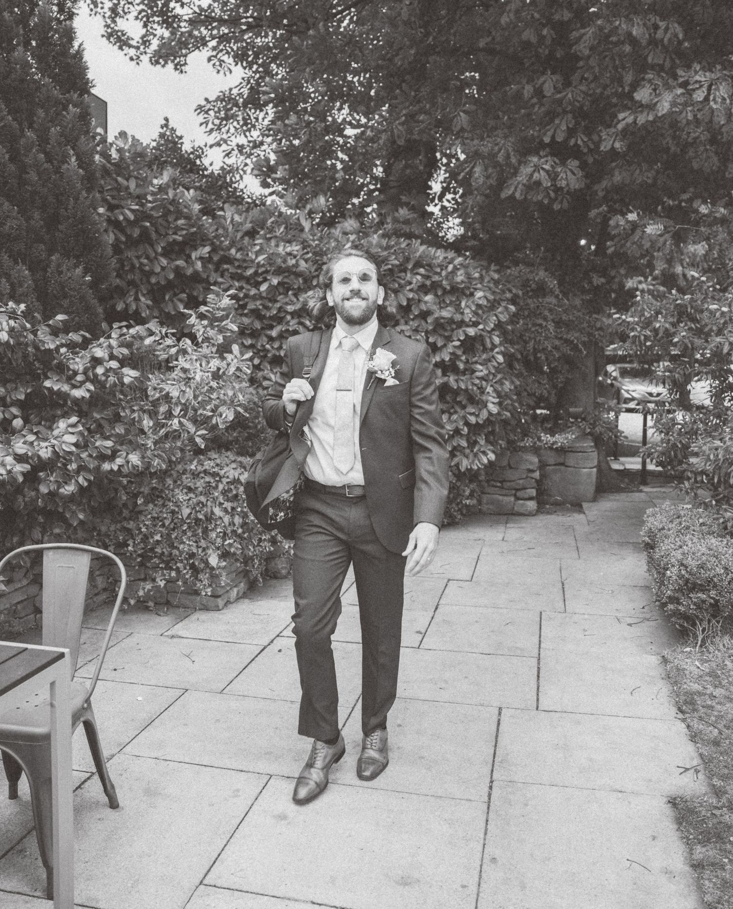 Sequence of black and white photos showing walking movement on stone pavement.