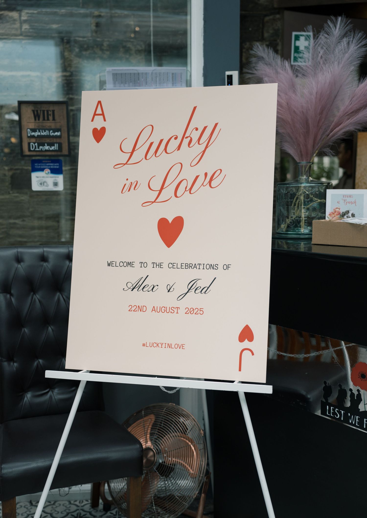 Wedding signage displays 'Lucky in Love' theme with playing card motifs.