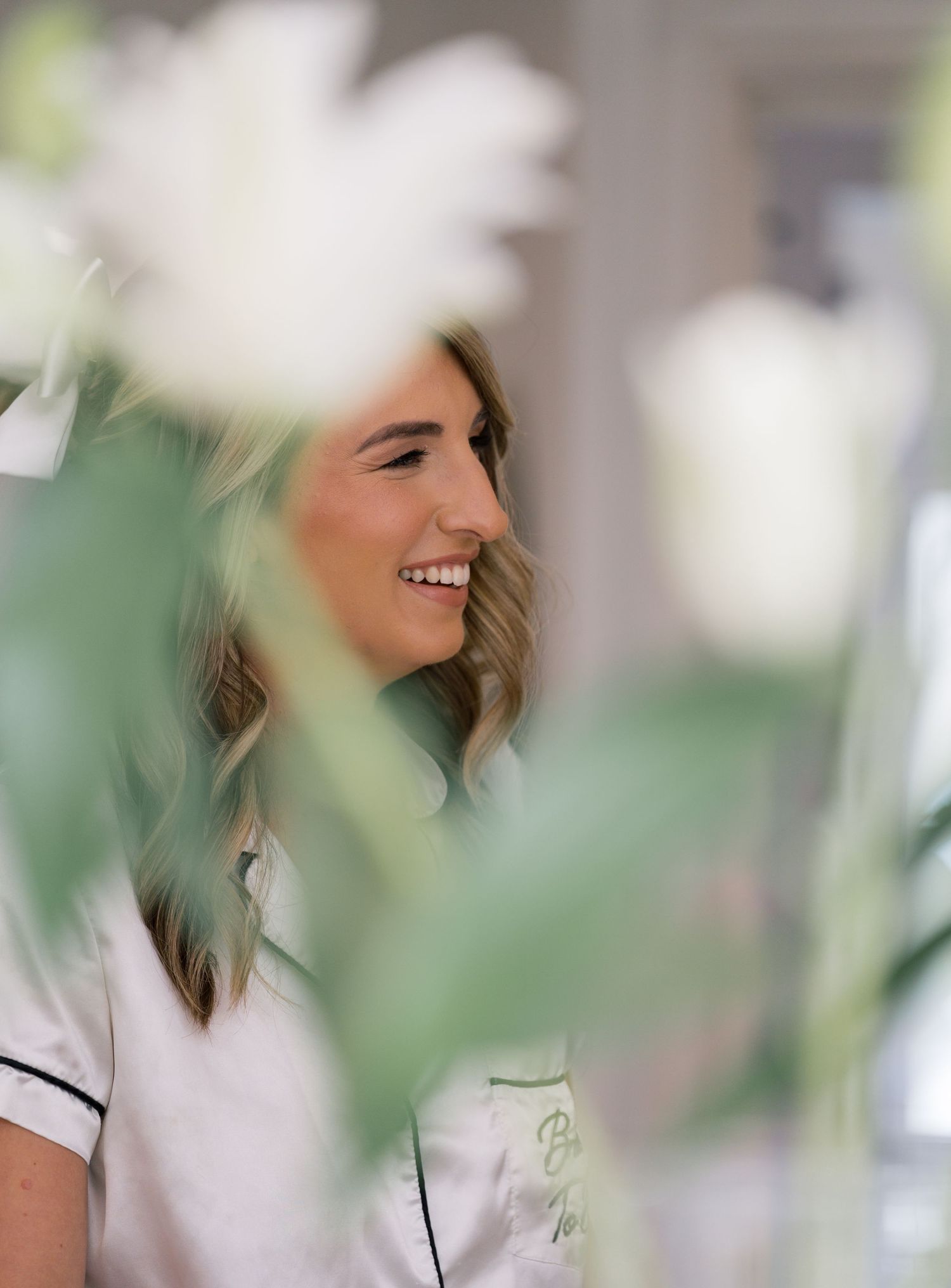 A series of candid portraits in white shirts against a soft green blurred background.
