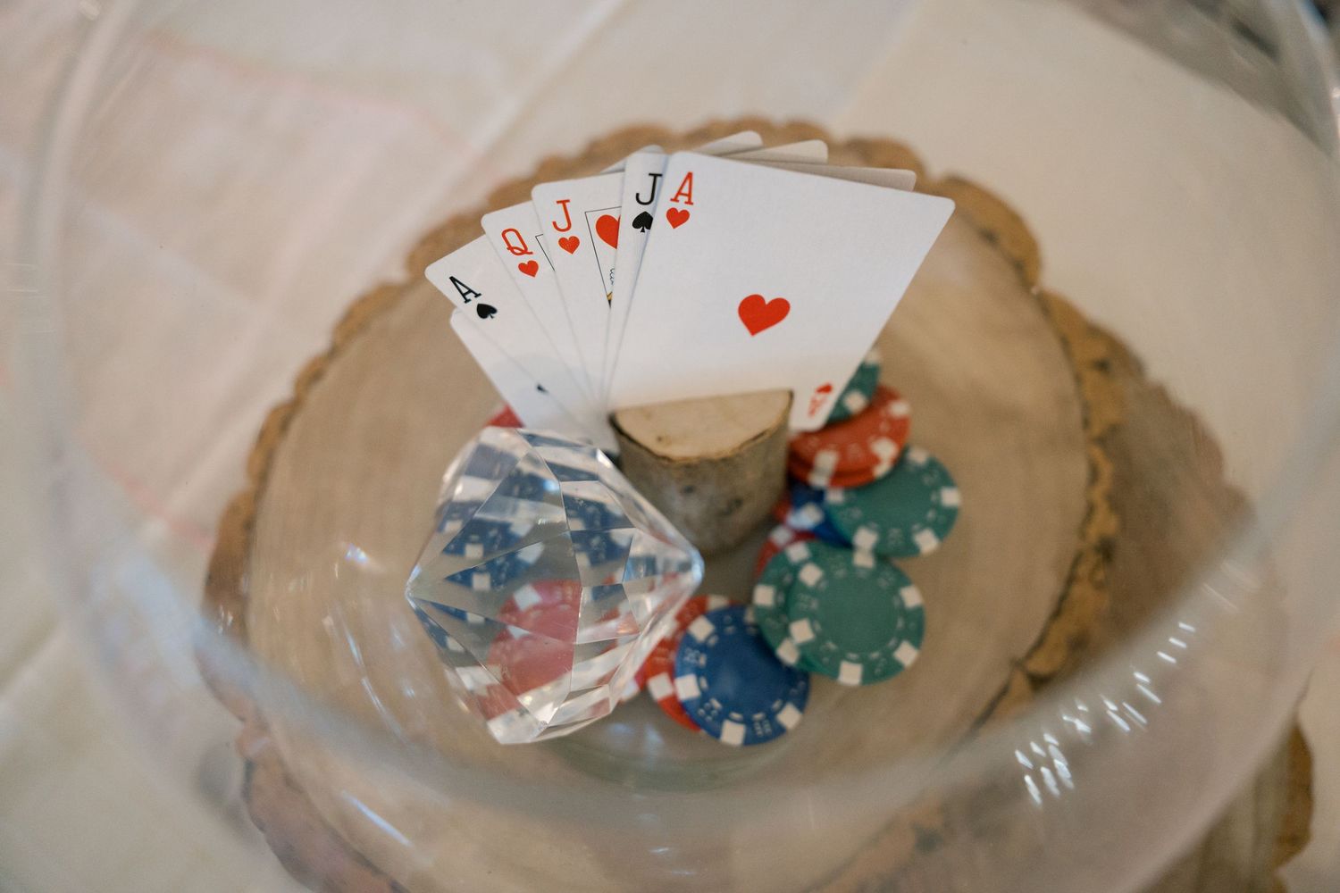 Playing cards and poker chips scattered on a beige surface.