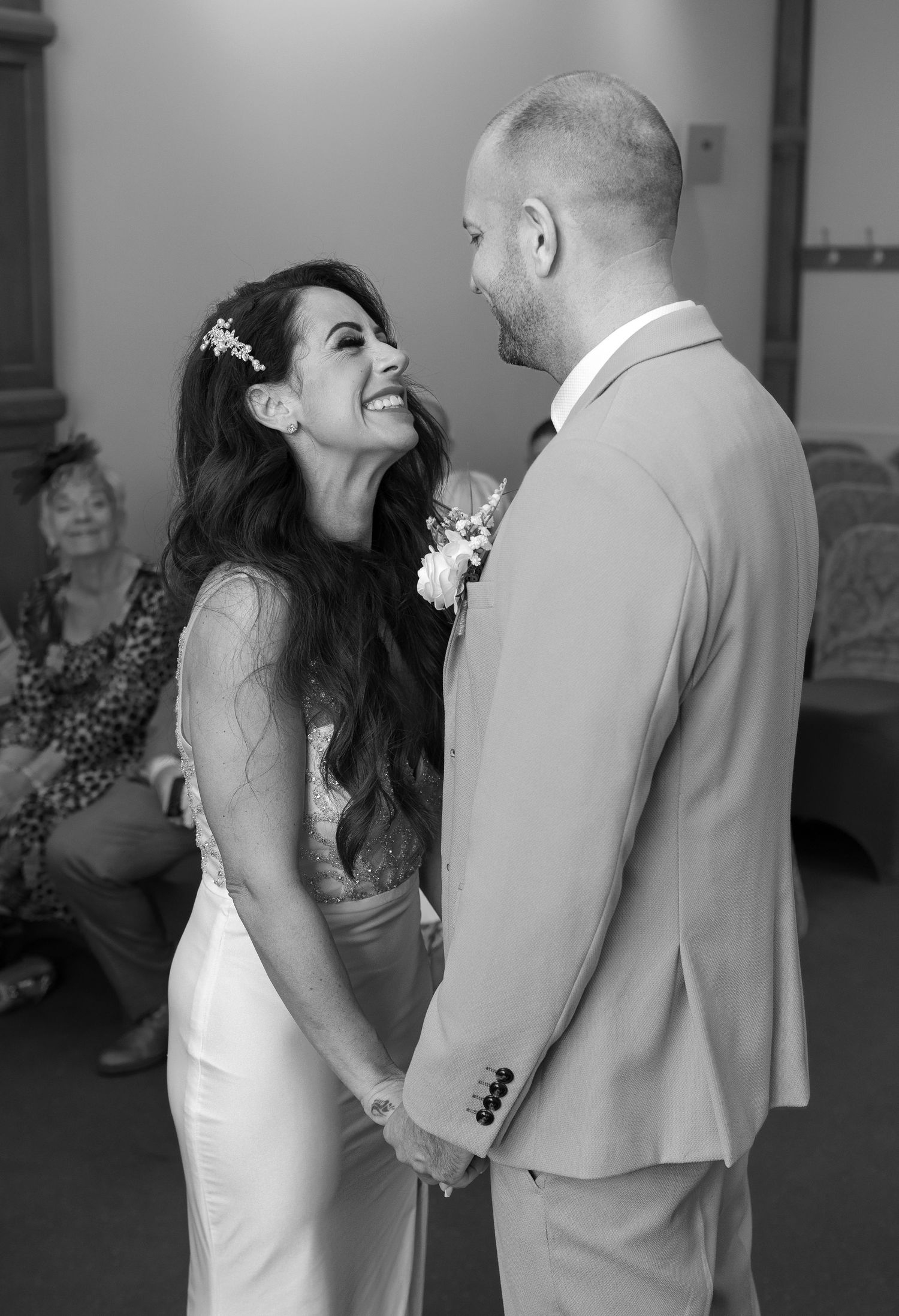 Intimate black and white moment shared between couple in formal wedding attire.