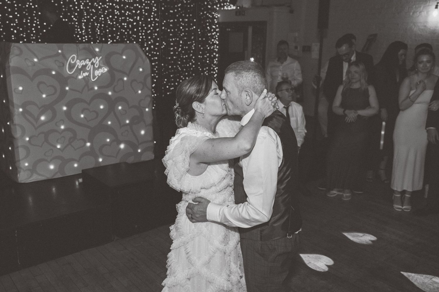 Wedding reception dance floor with string lights creating a romantic atmosphere.