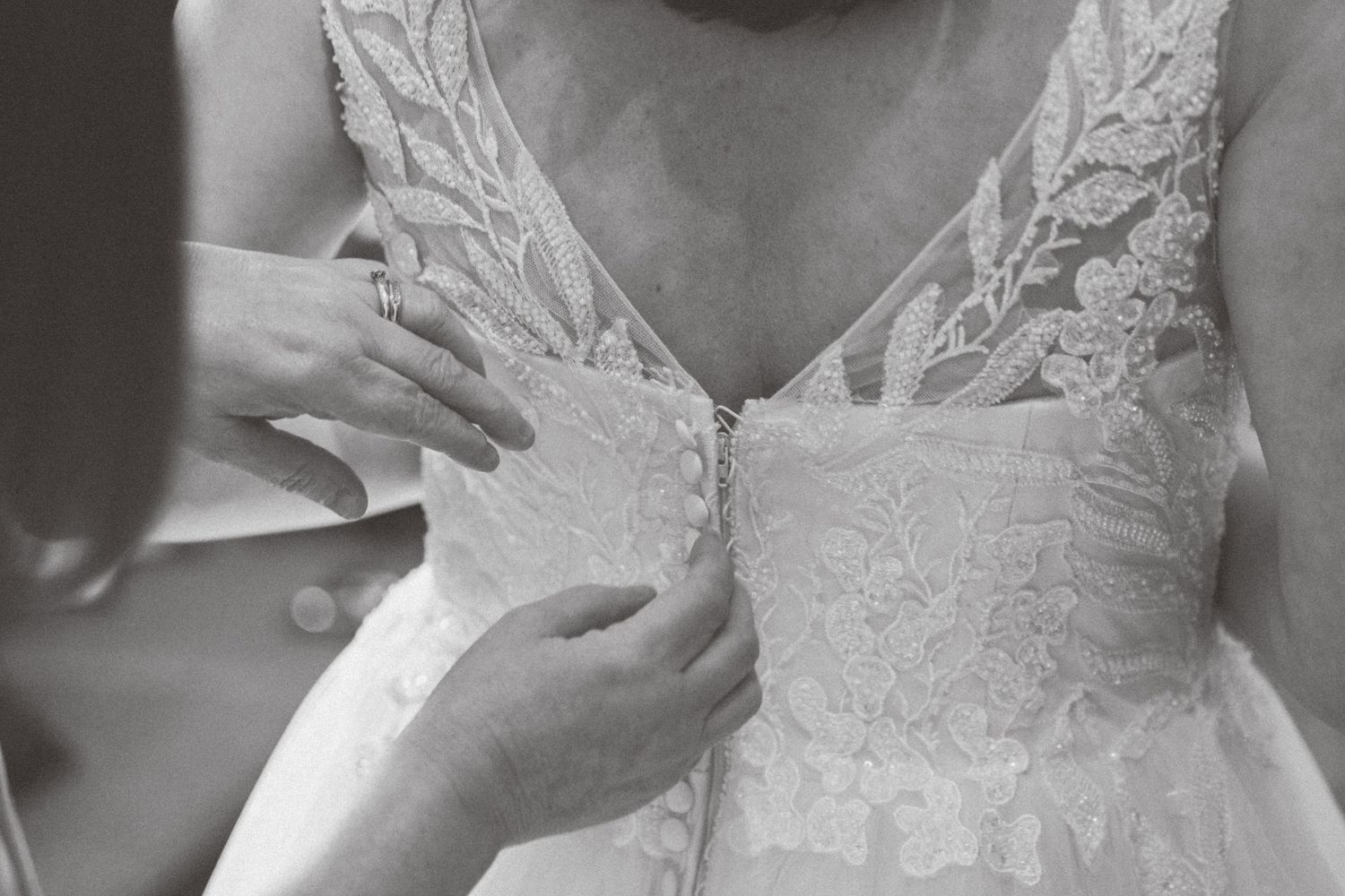 A collection of close-up photos showing intricate lace details and beading on a white wedding dress.