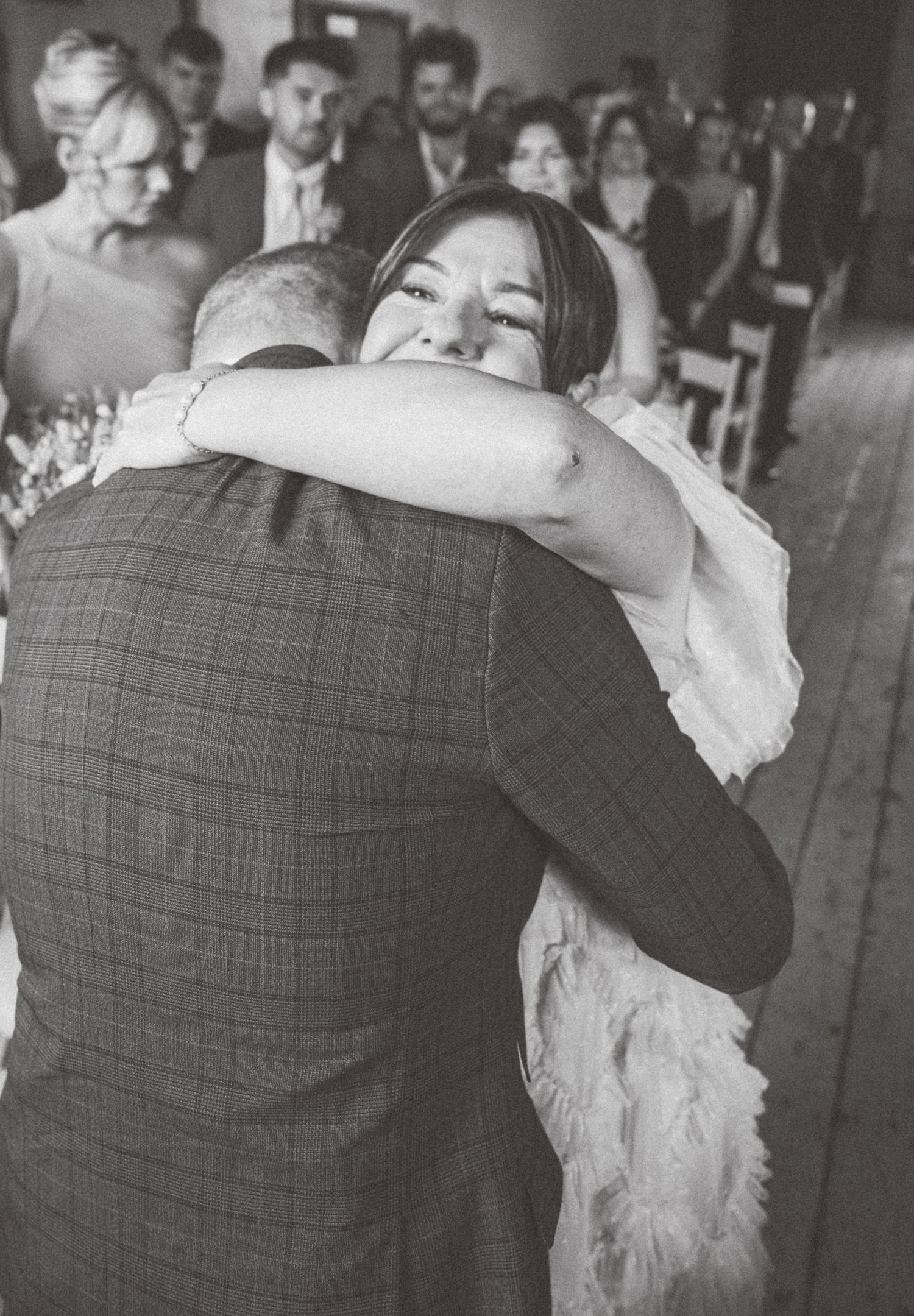 A black and white sequence showing a couple dancing together at a formal event.