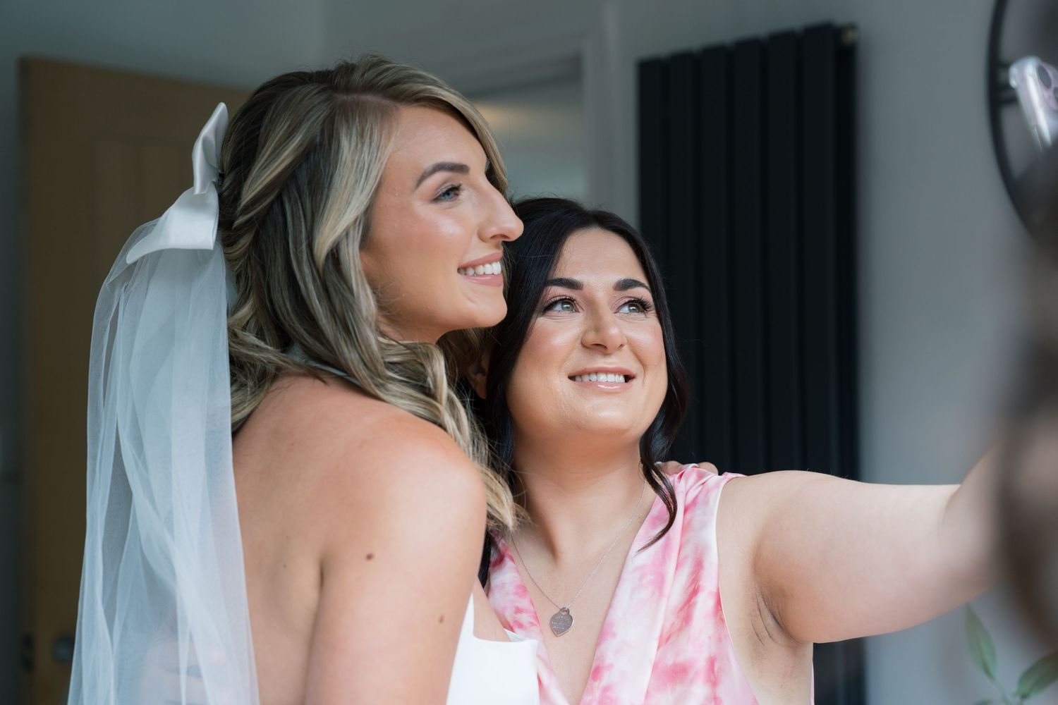Wedding preparation moments captured in a bright modern room with natural lighting.