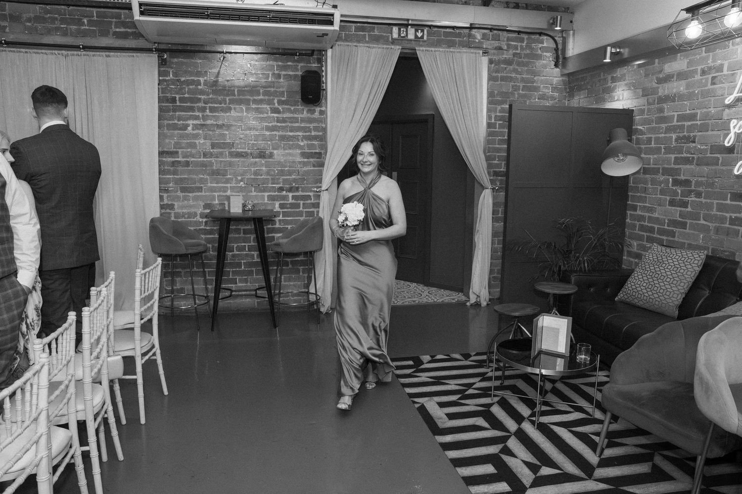 Black and white photos showing an empty wedding venue with brick walls and white chairs.