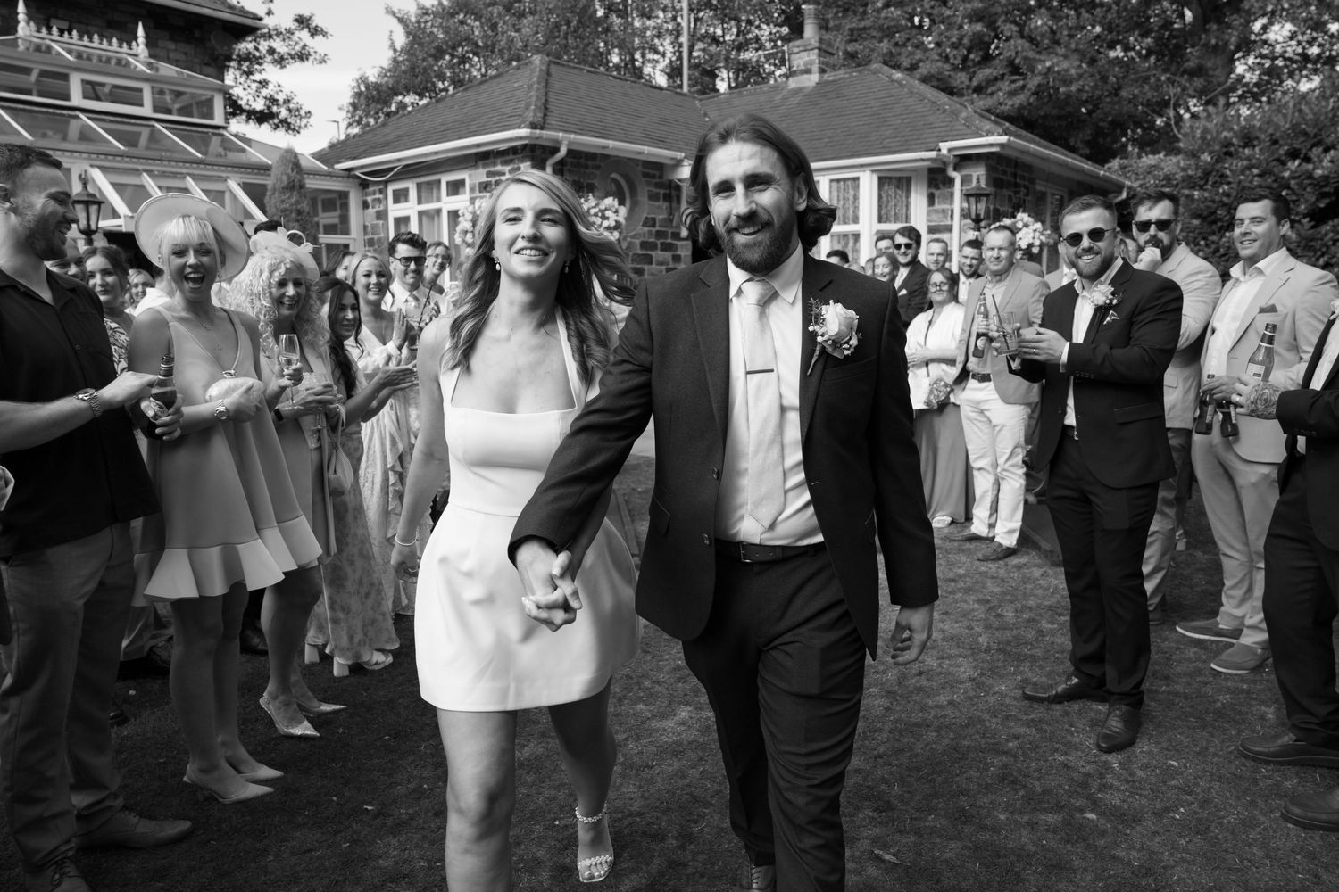 Wedding guests dance and celebrate on an outdoor dance floor during the reception.