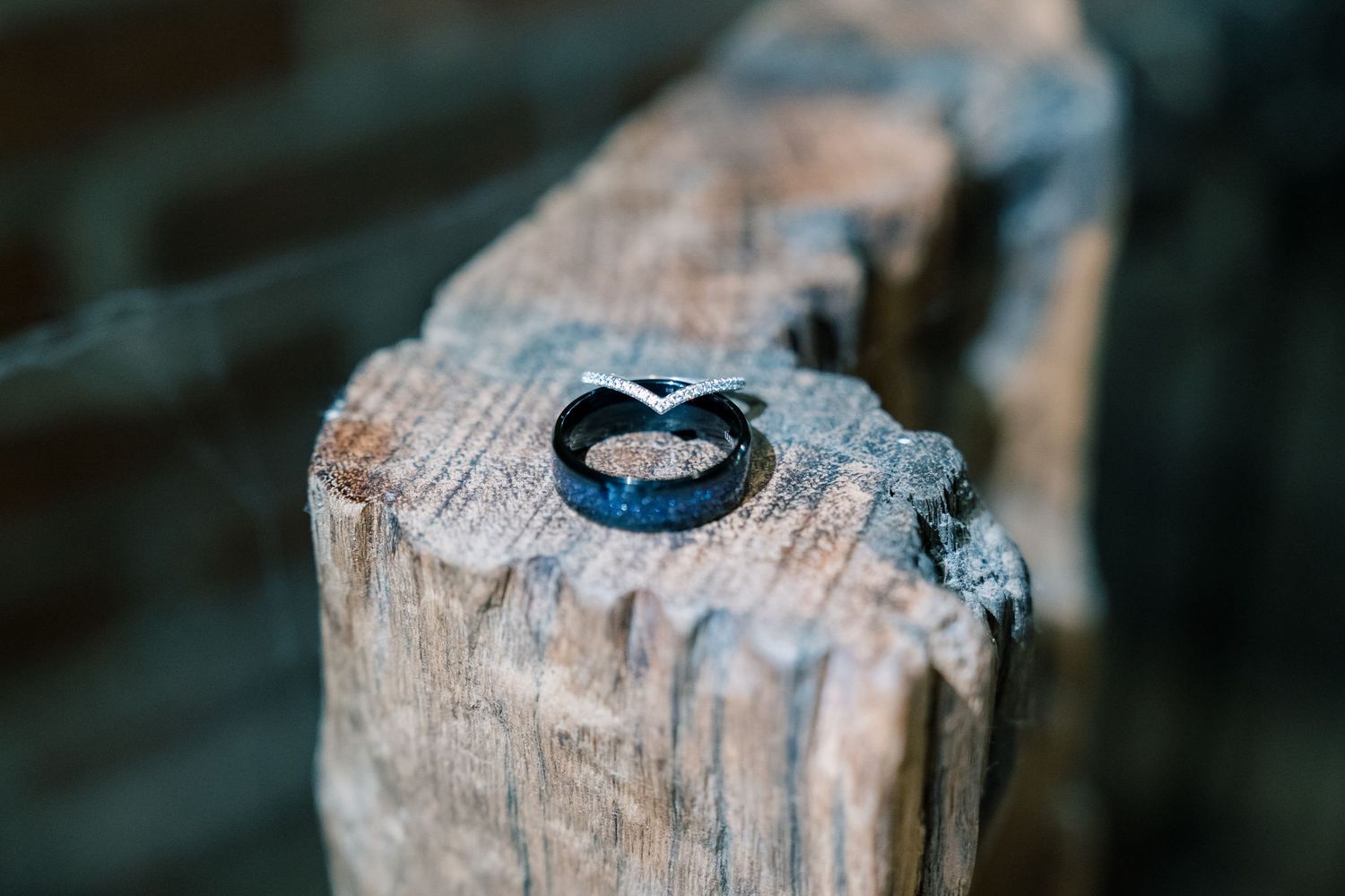 Rustic heart shape carved into weathered wooden logs creates a romantic natural detail.