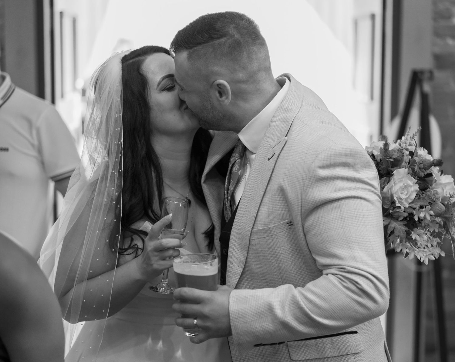 Romantic black and white wedding portrait with couple sharing an intimate moment.