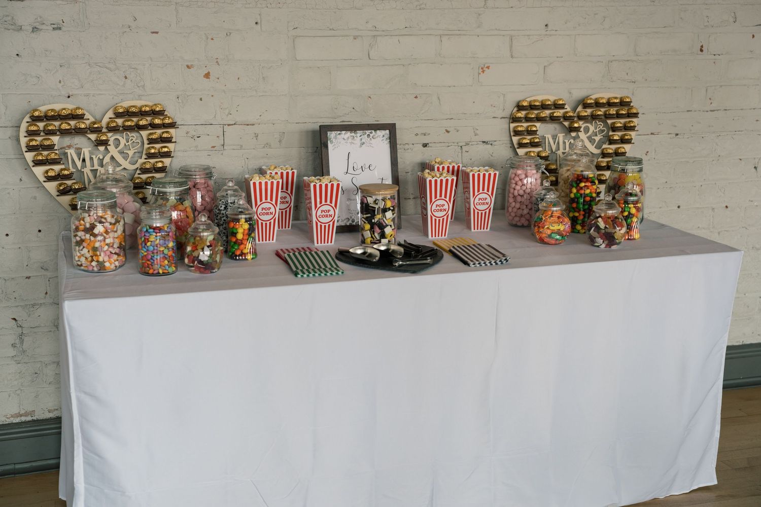 Display tables lined with various collectible toys and figurines at what appears to be a convention or vendor setup.