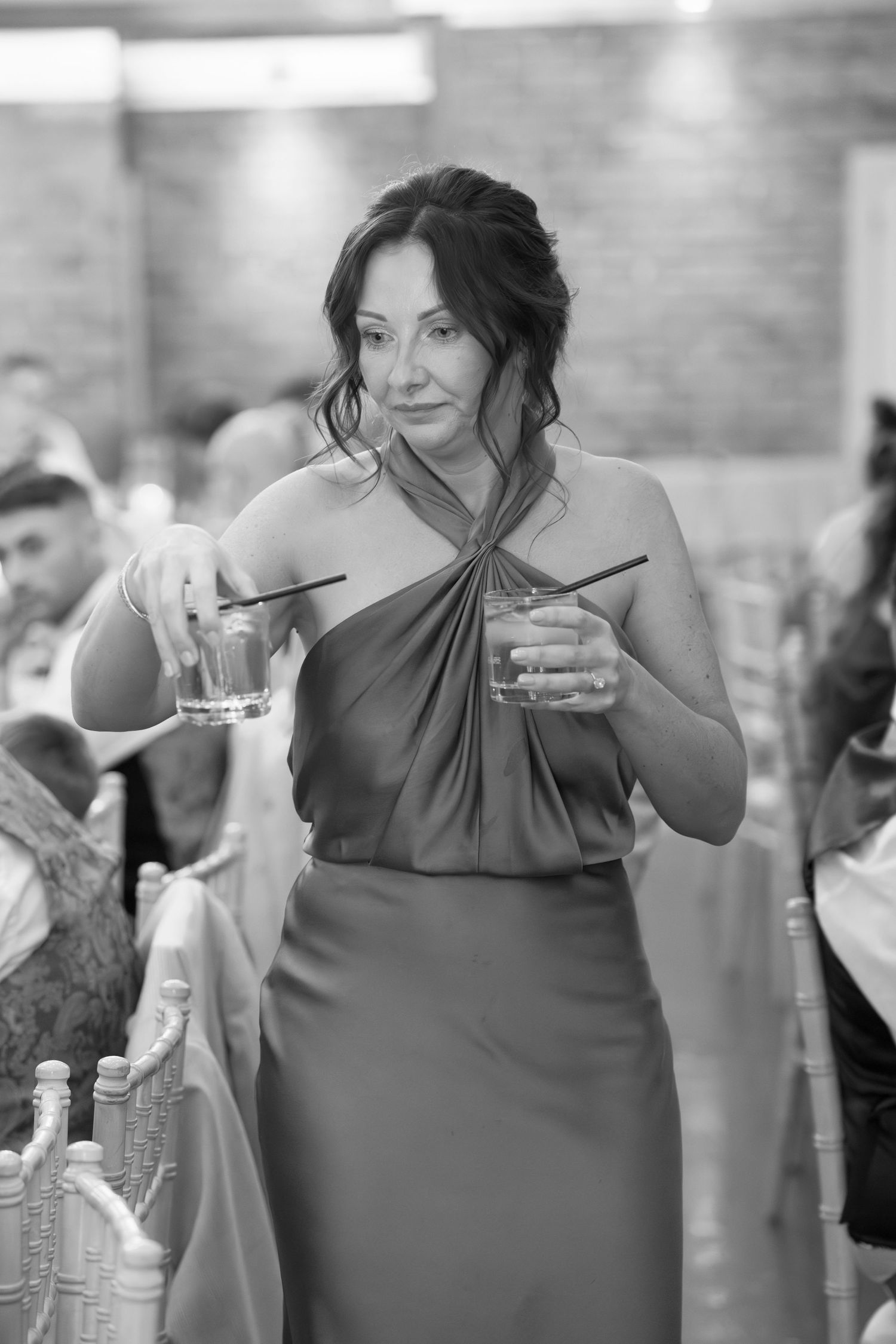 A series of candid shots showing someone in a gray dress enjoying appetizers at an elegant event.