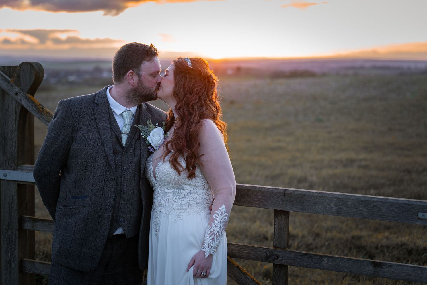 A romantic sunset wedding portrait with a couple sharing an intimate moment.