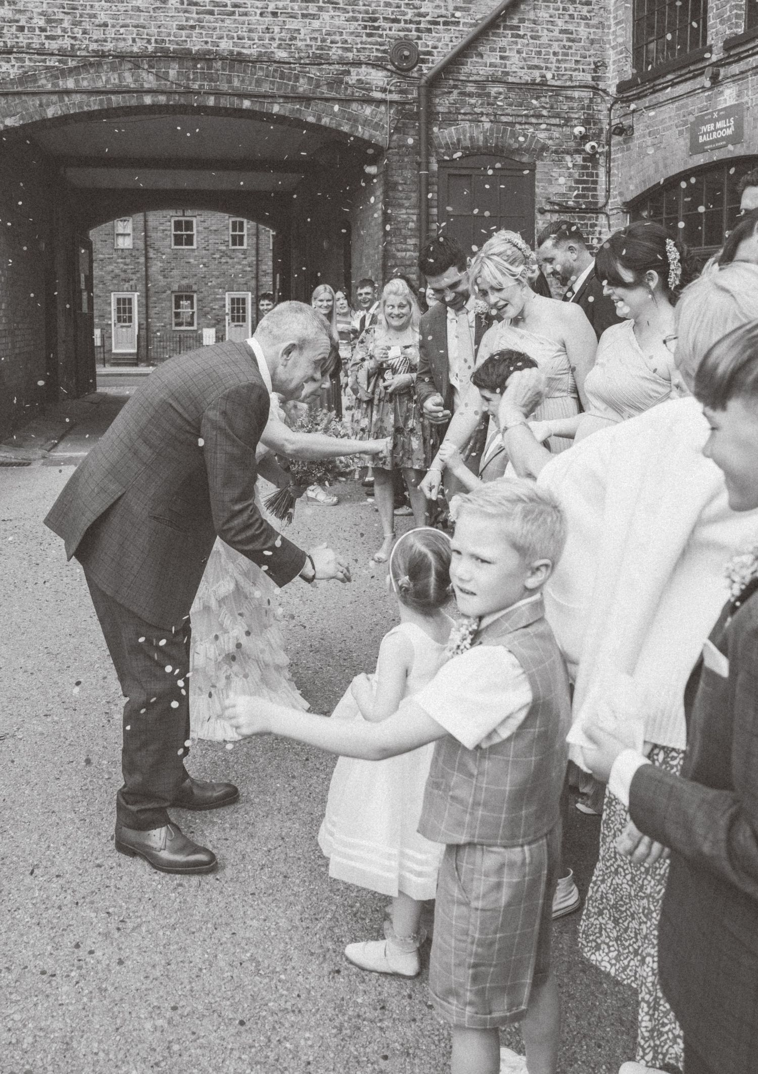 Black and white photos show guests celebrating at an outdoor wedding reception.