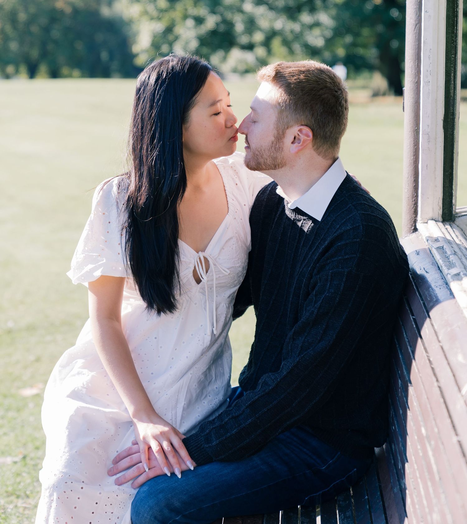 A tender romantic moment shared between a couple in formal attire outdoors.
