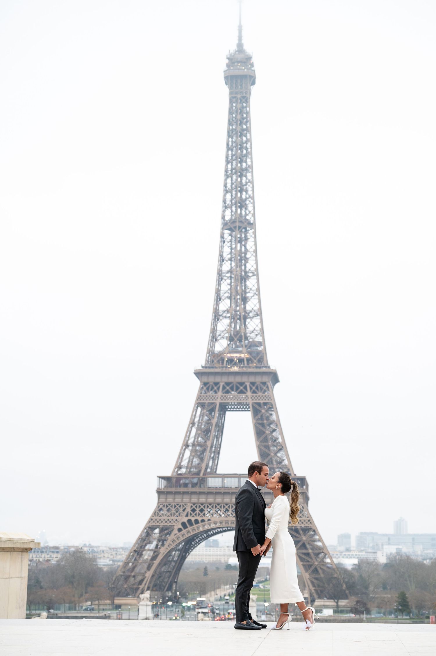 A couple shares a romantic moment near the iconic Eiffel Tower in Paris with three views of their special day.
