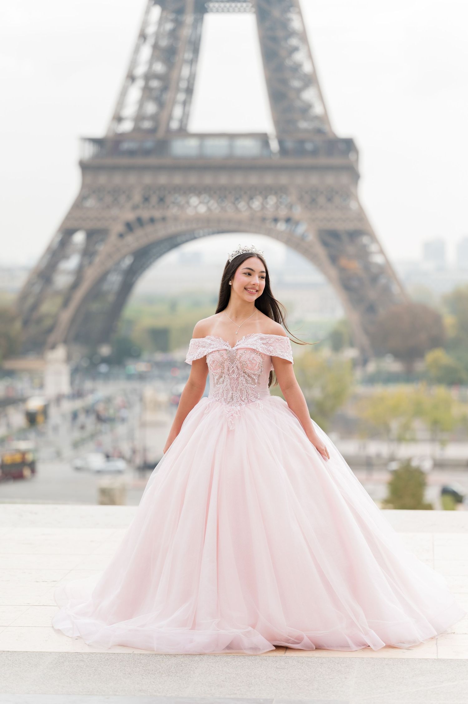 A pink ballgown dress photographed in multiple angles with the iconic Eiffel Tower in Paris as the backdrop.