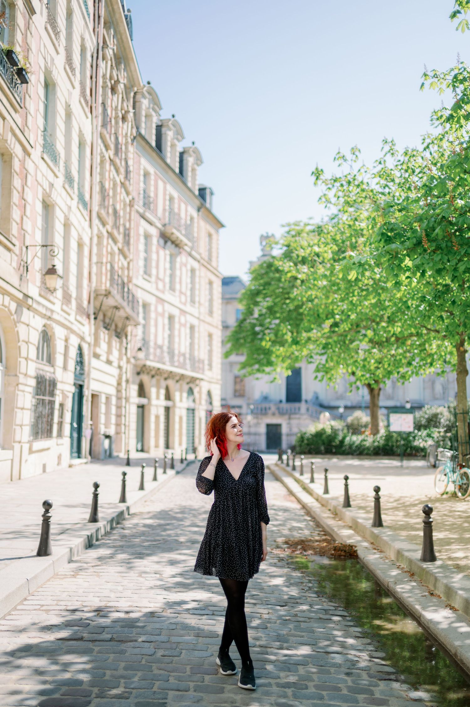 A set of fashion photos along a cobblestone street in Paris with classic Haussmann buildings in background.