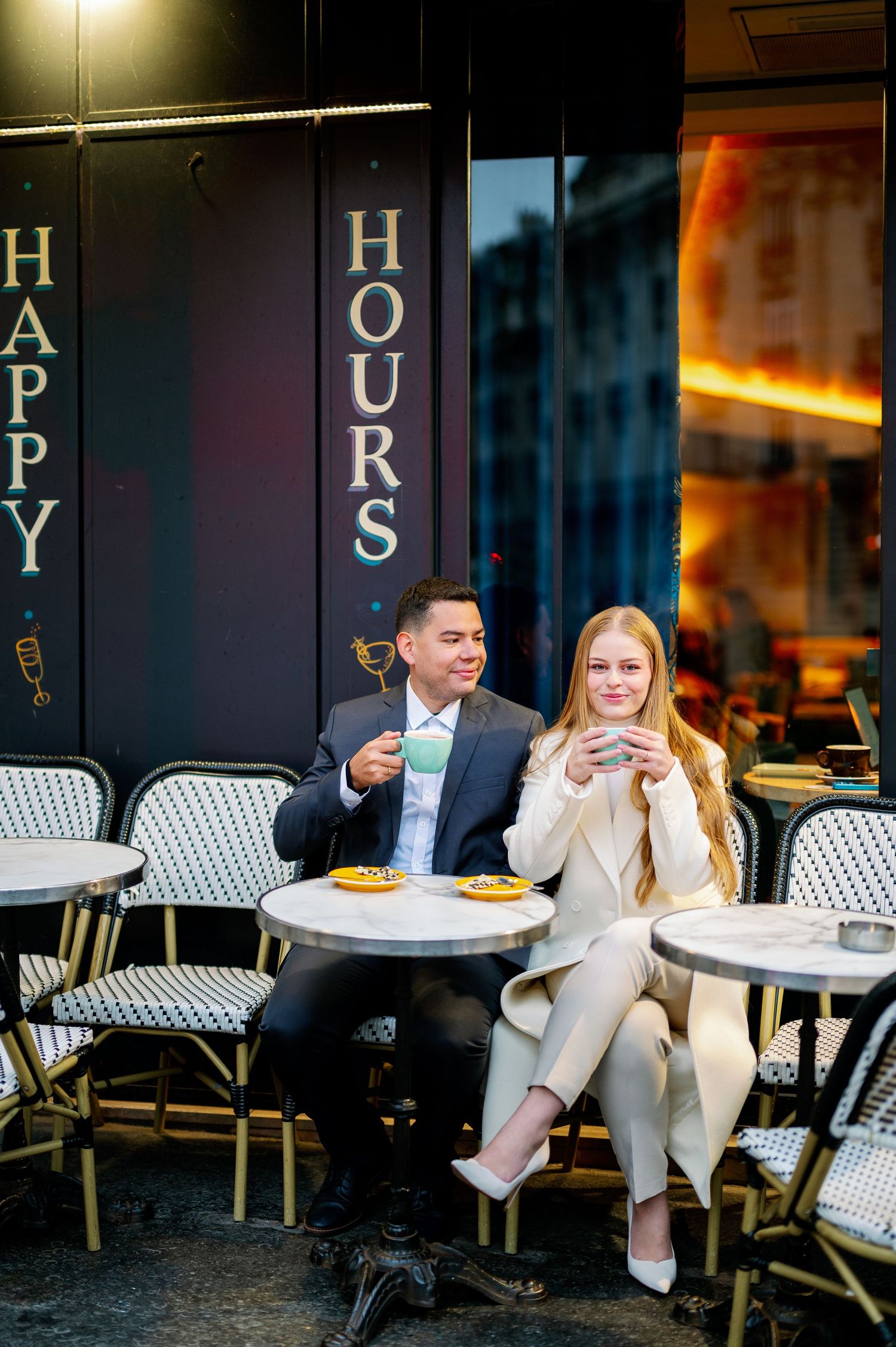 Cafe scene at Happy Hours in Paris with outdoor seating and classic bistro atmosphere.