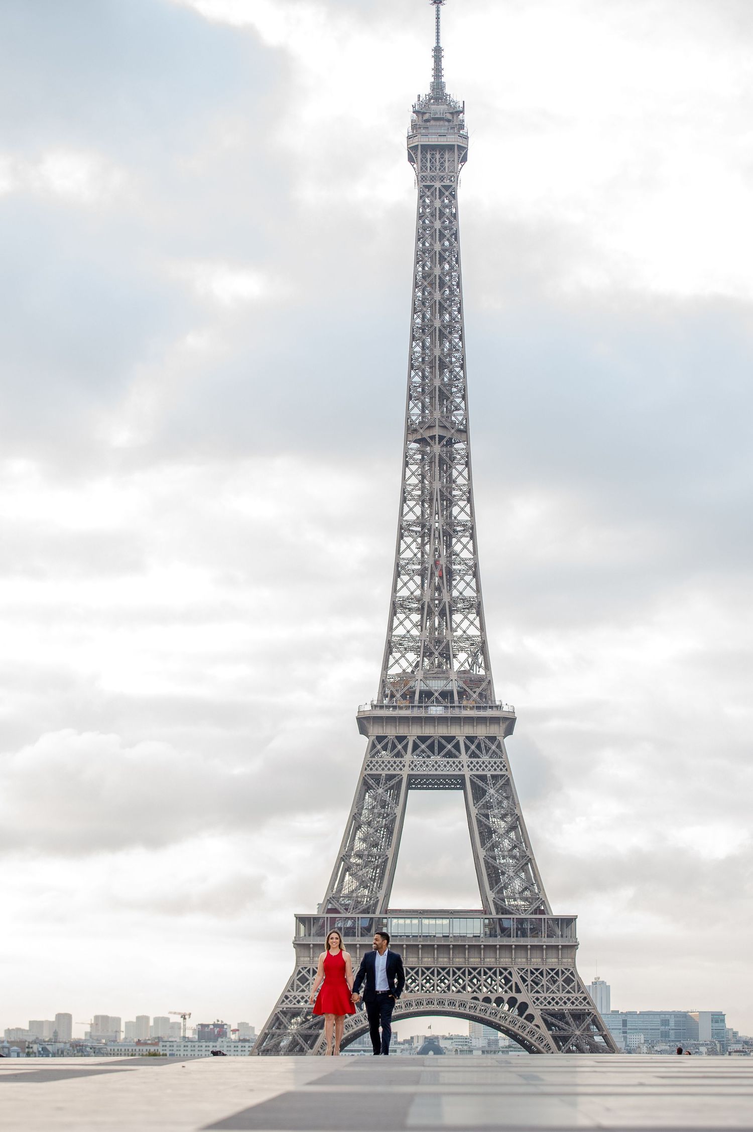 The iconic Eiffel Tower stands tall against cloudy skies at Trocadero Plaza in Paris, France.