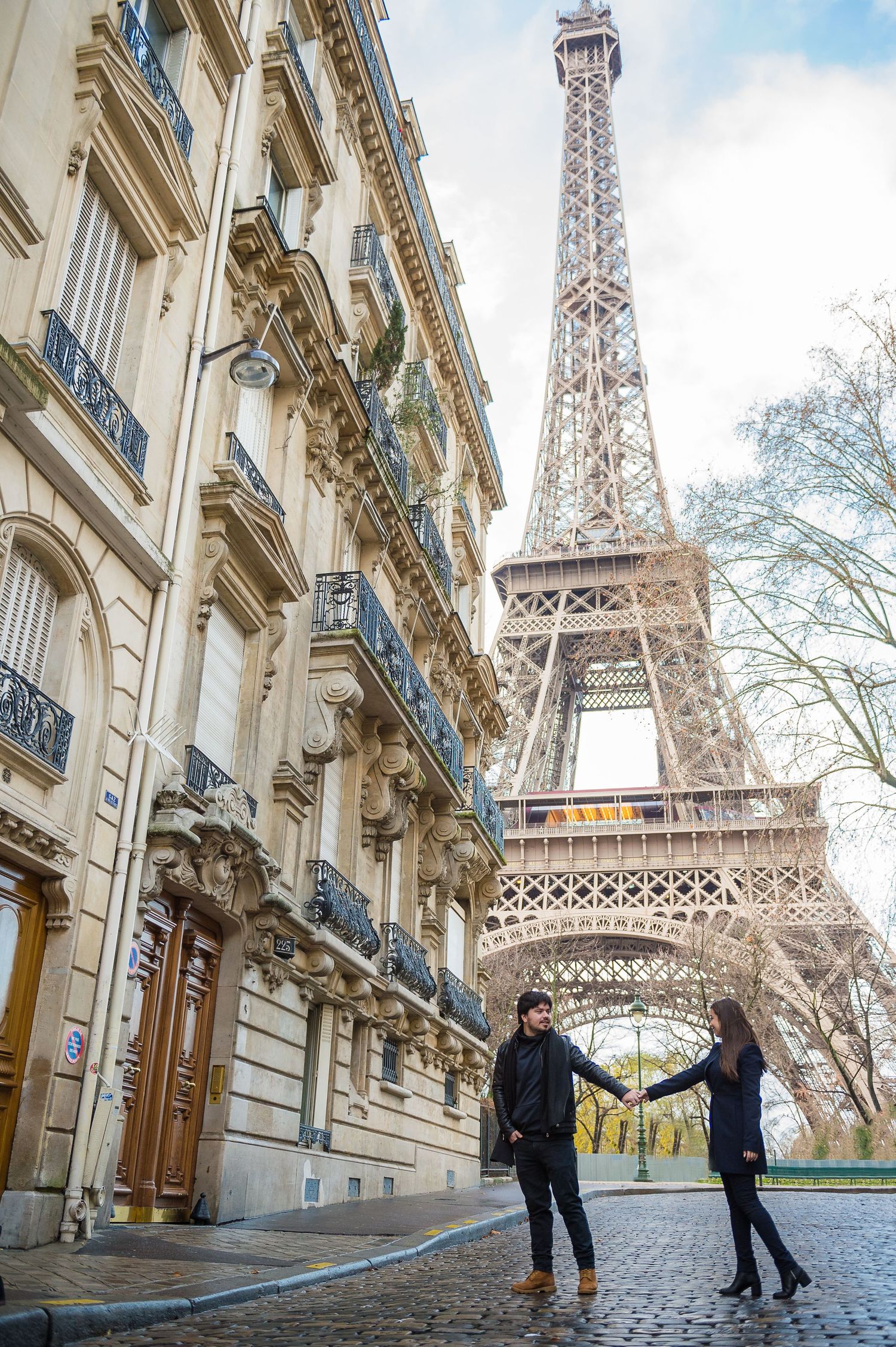 Elegant Parisian street with classic architecture and the iconic Eiffel Tower rising majestically in the background.