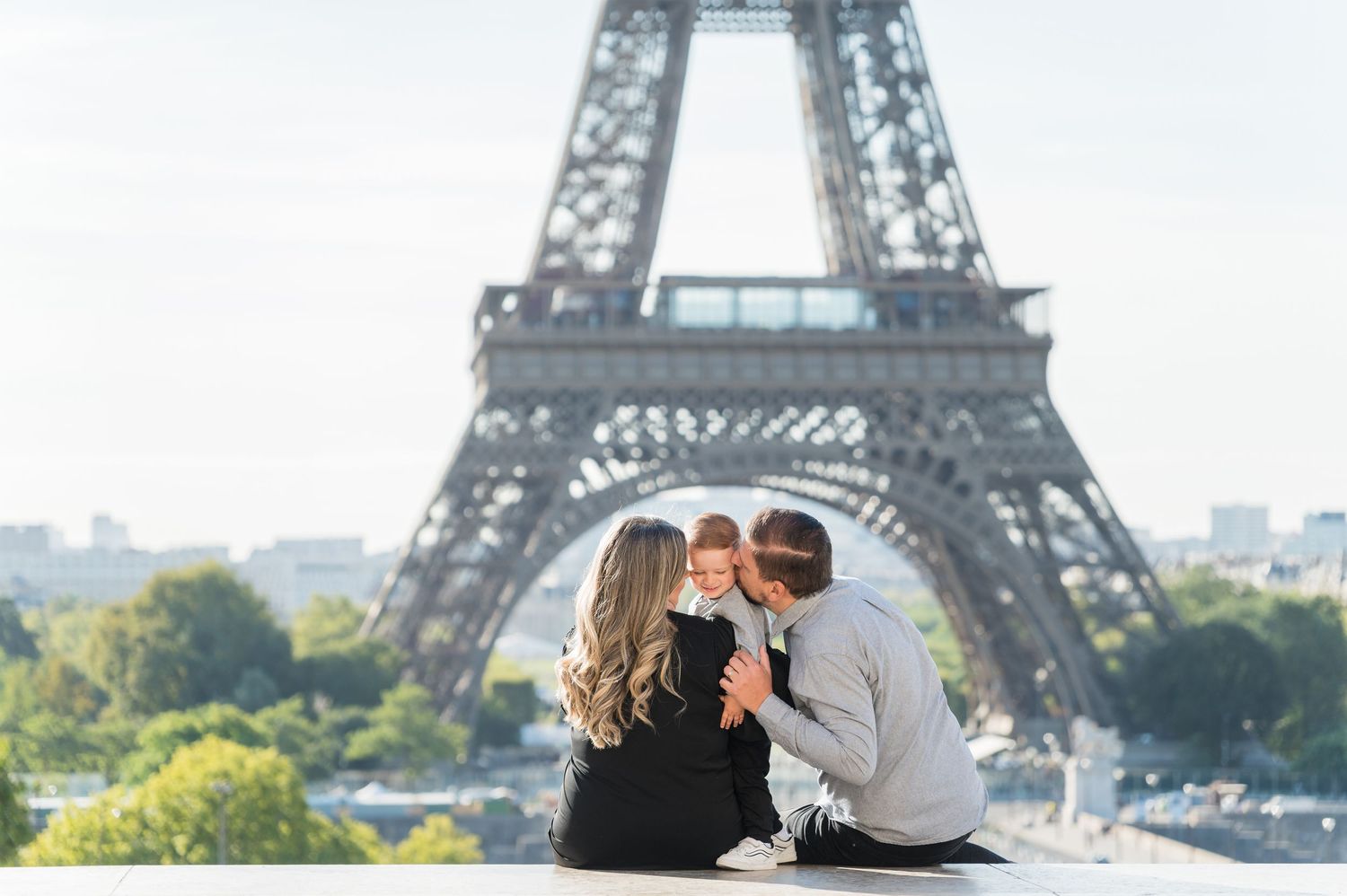 A couple enjoys a romantic moment with the iconic Eiffel Tower in Paris as their backdrop.