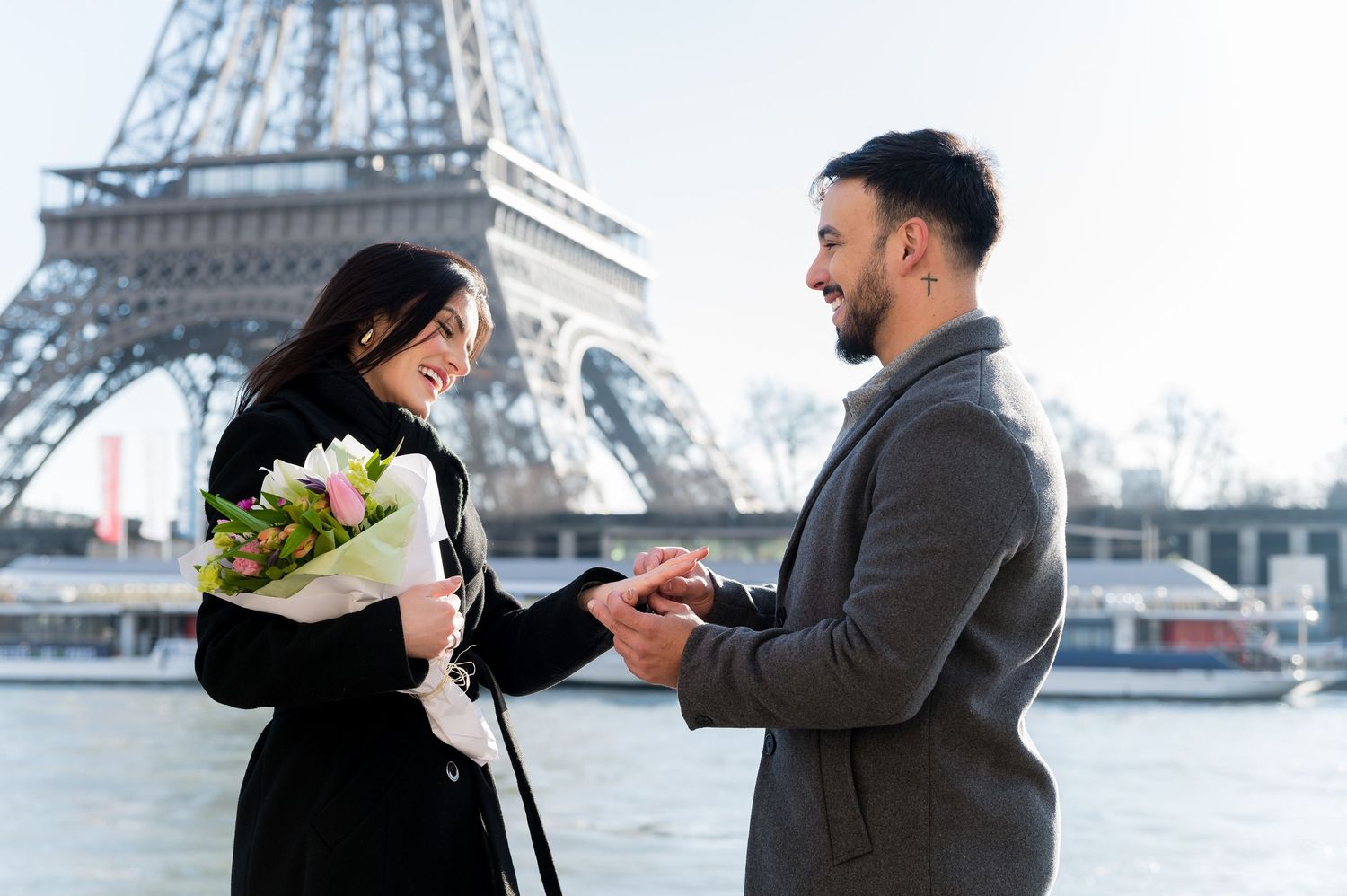 A romantic proposal scene unfolds along the Seine River with the Eiffel Tower in the background.