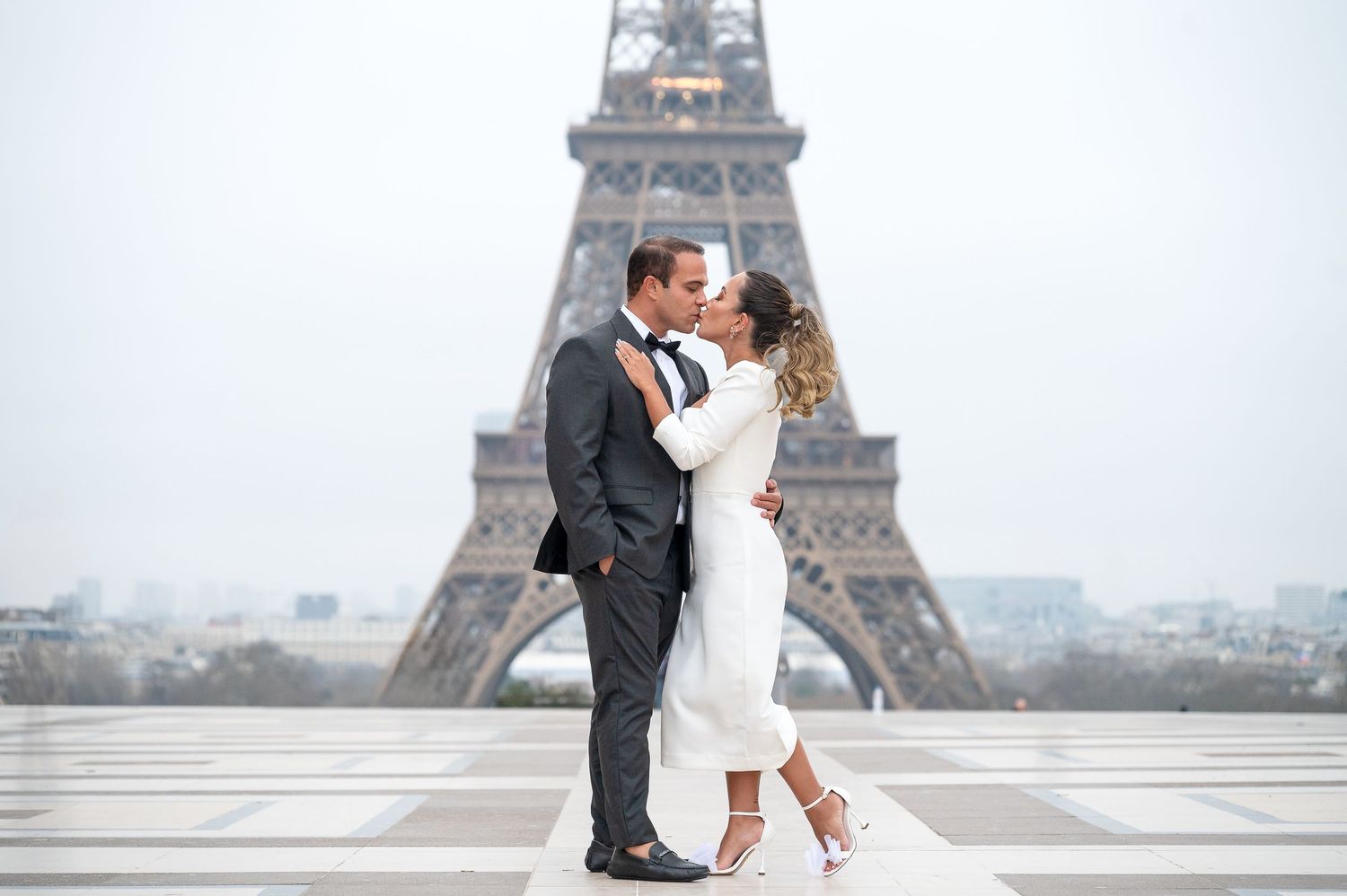A dreamy and romantic montage of wedding photos captured at the iconic Eiffel Tower in Paris during an overcast day.