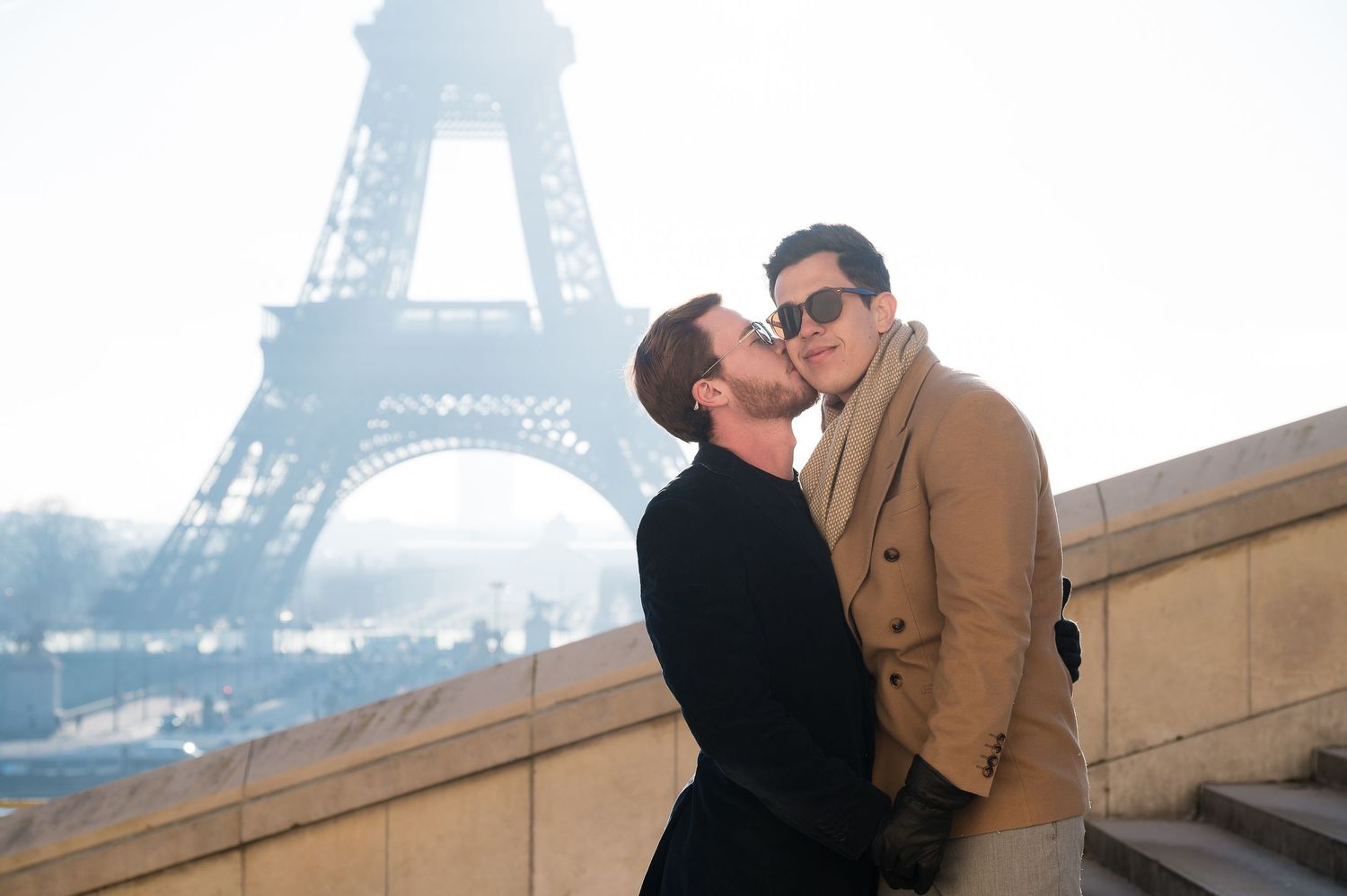 A romantic moment shared at the Trocadero with the Eiffel Tower in the misty background.