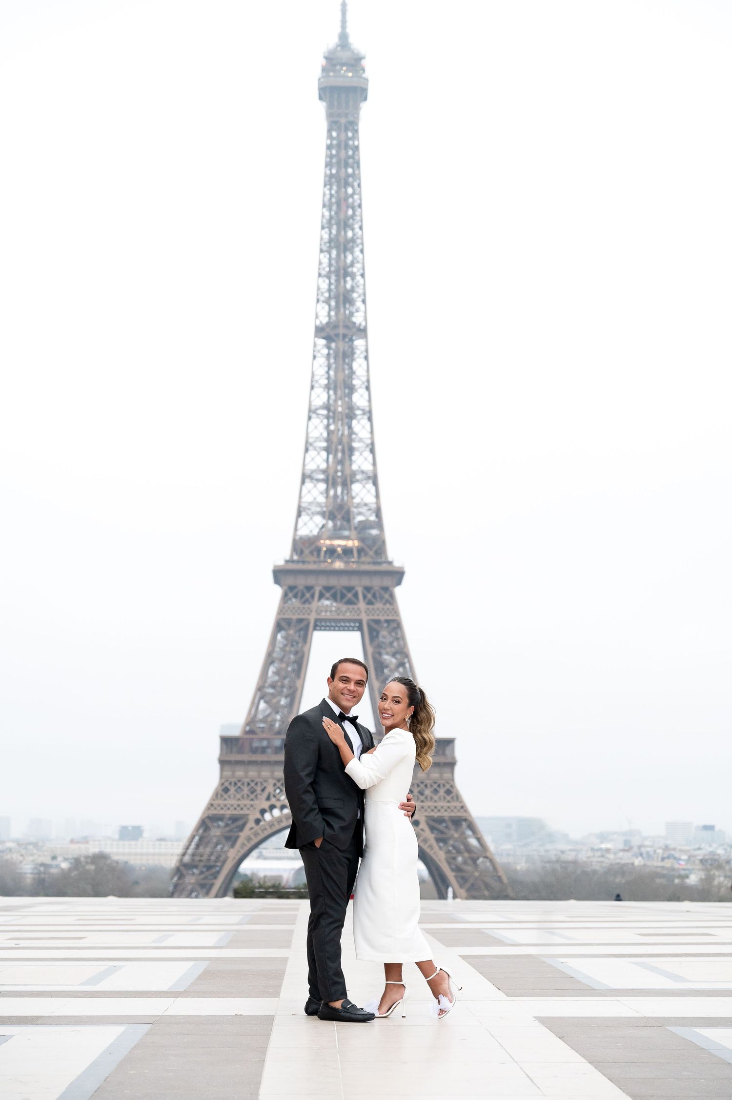 Romantic wedding photo of couple dancing in front of the Eiffel Tower.