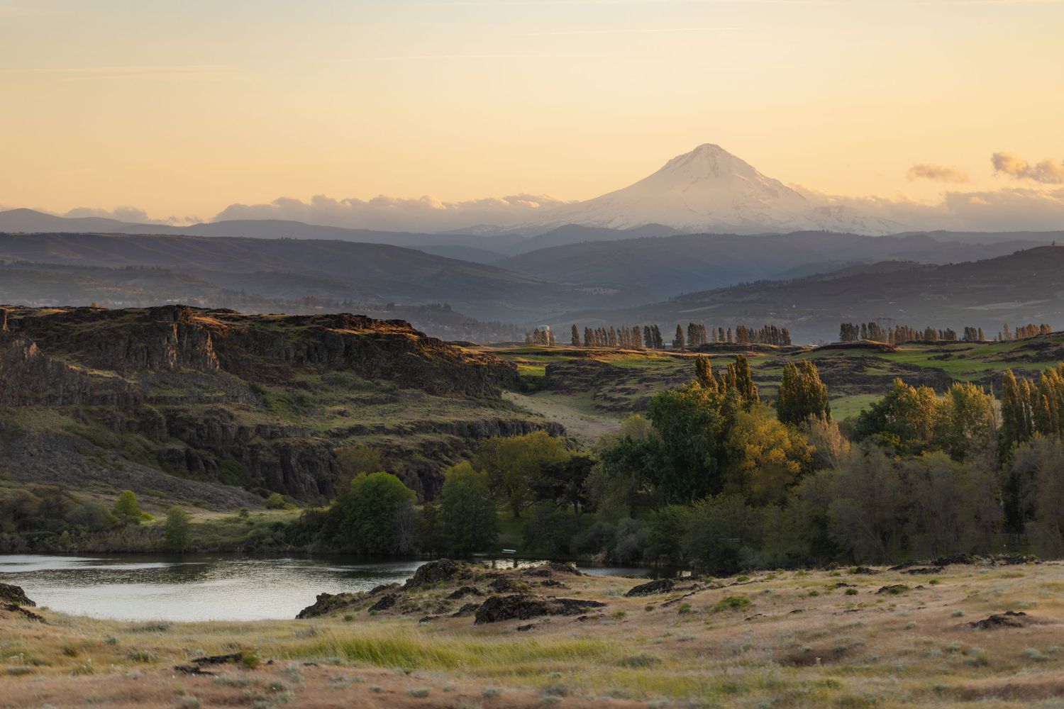 Mountain landscape view of the Columbia River Gorge with dramatic sunset lighting.