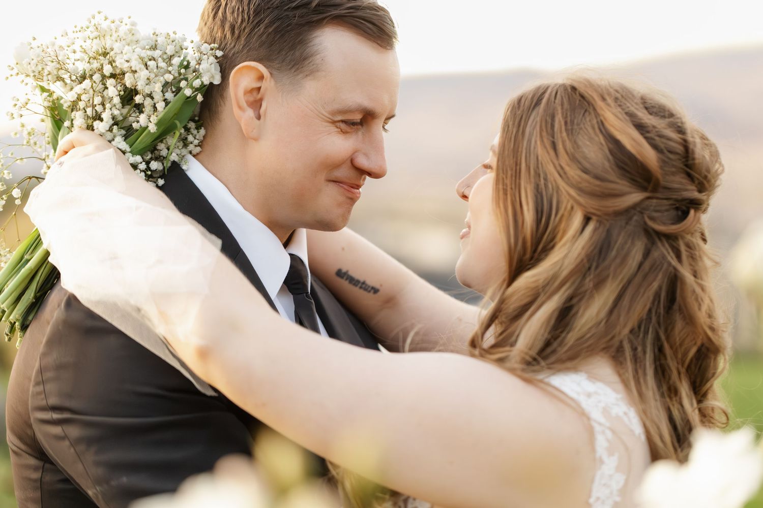 Intimate wedding portrait showing tender moments between newlyweds in soft natural light.