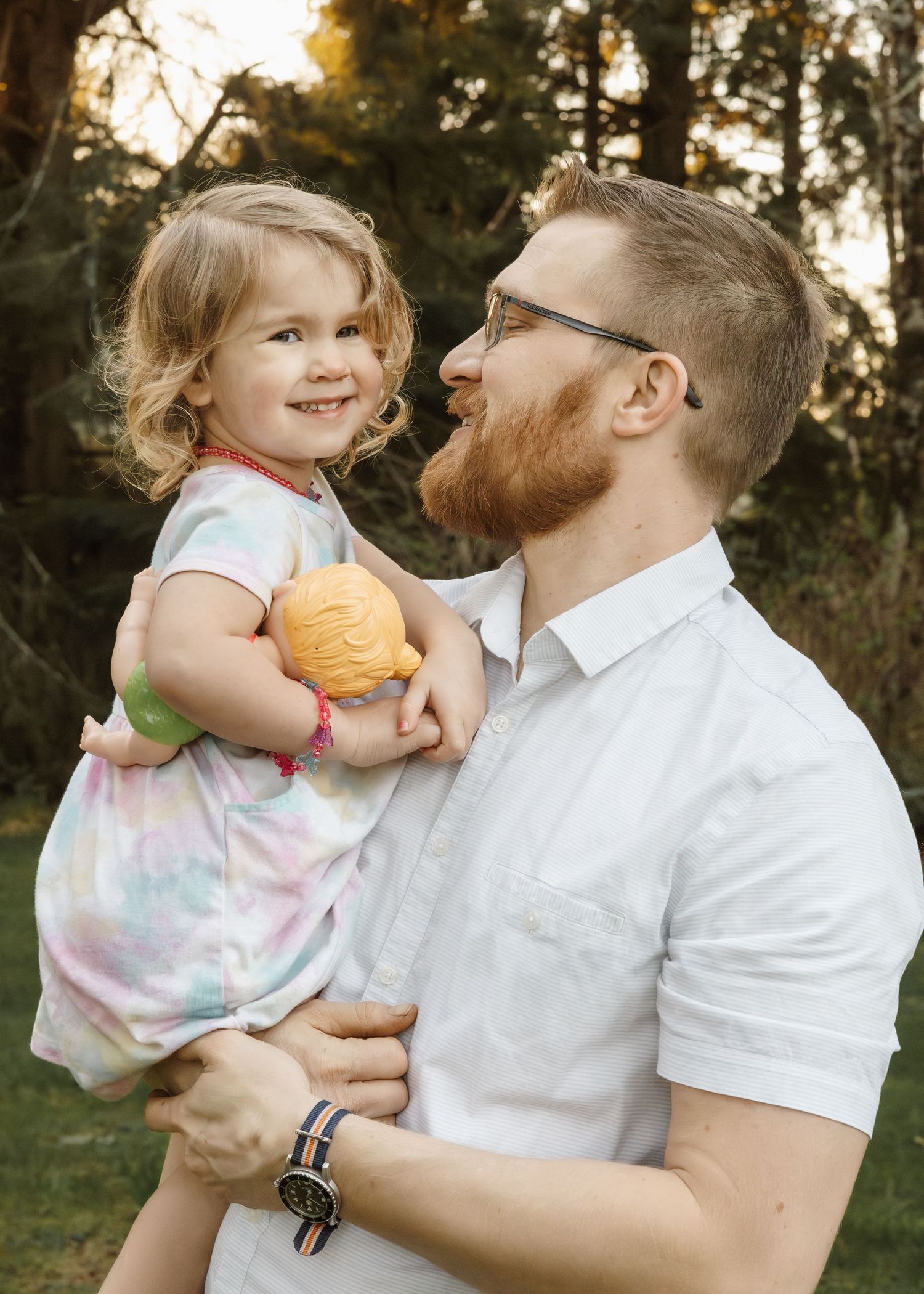 Candid family moments captured in warm sunset lighting outdoors.