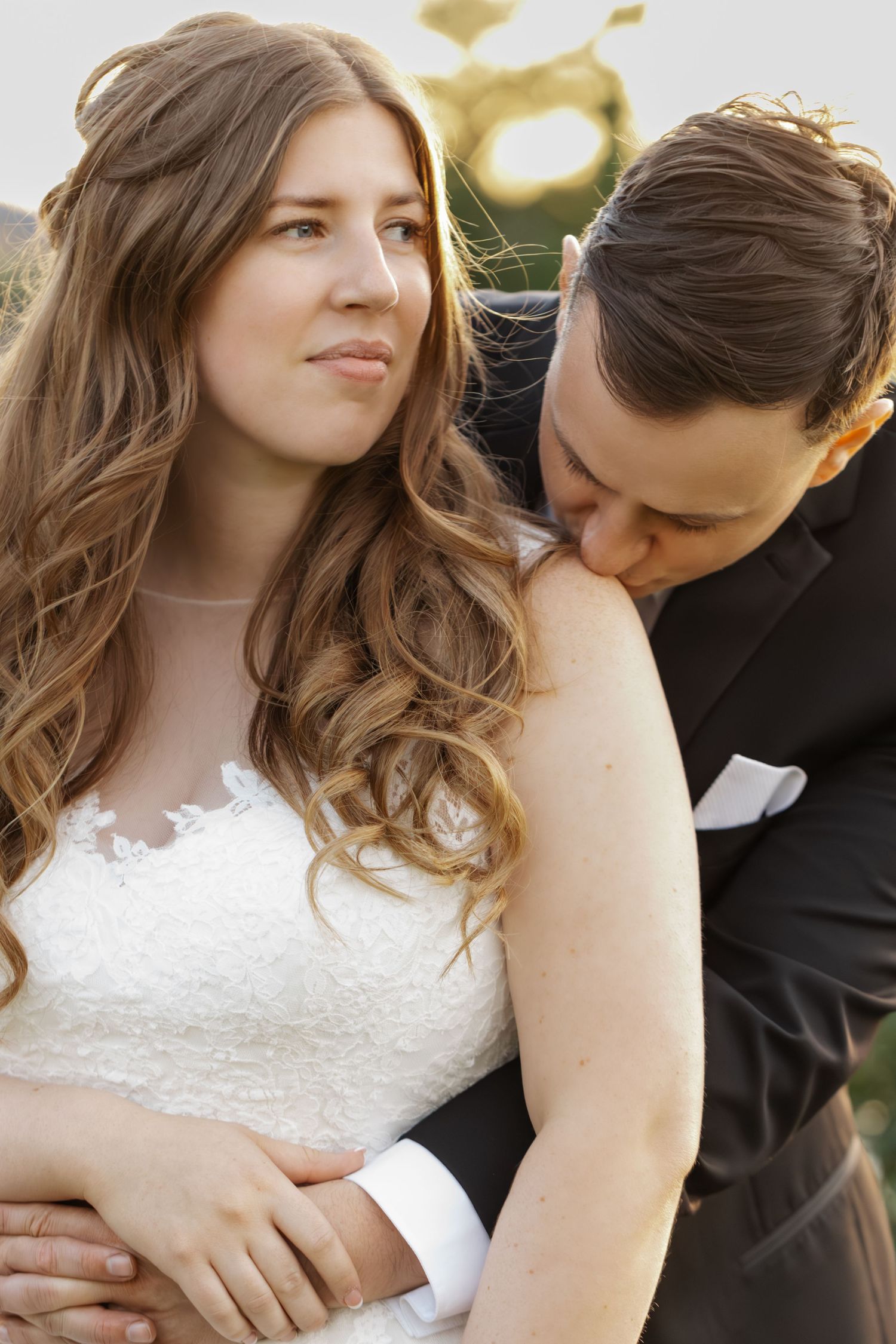 Romantic wedding portrait captured during golden hour with soft natural lighting.