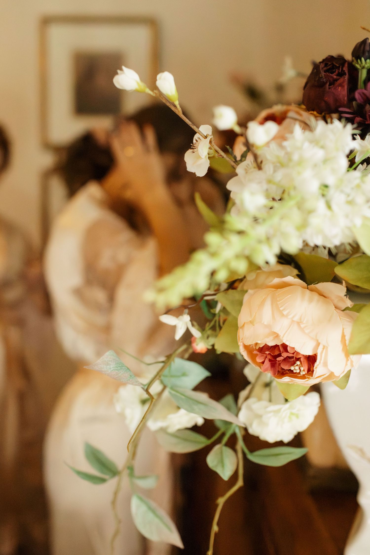 Delicate floral wedding bouquet with white blooms and eucalyptus leaves in soft focus.