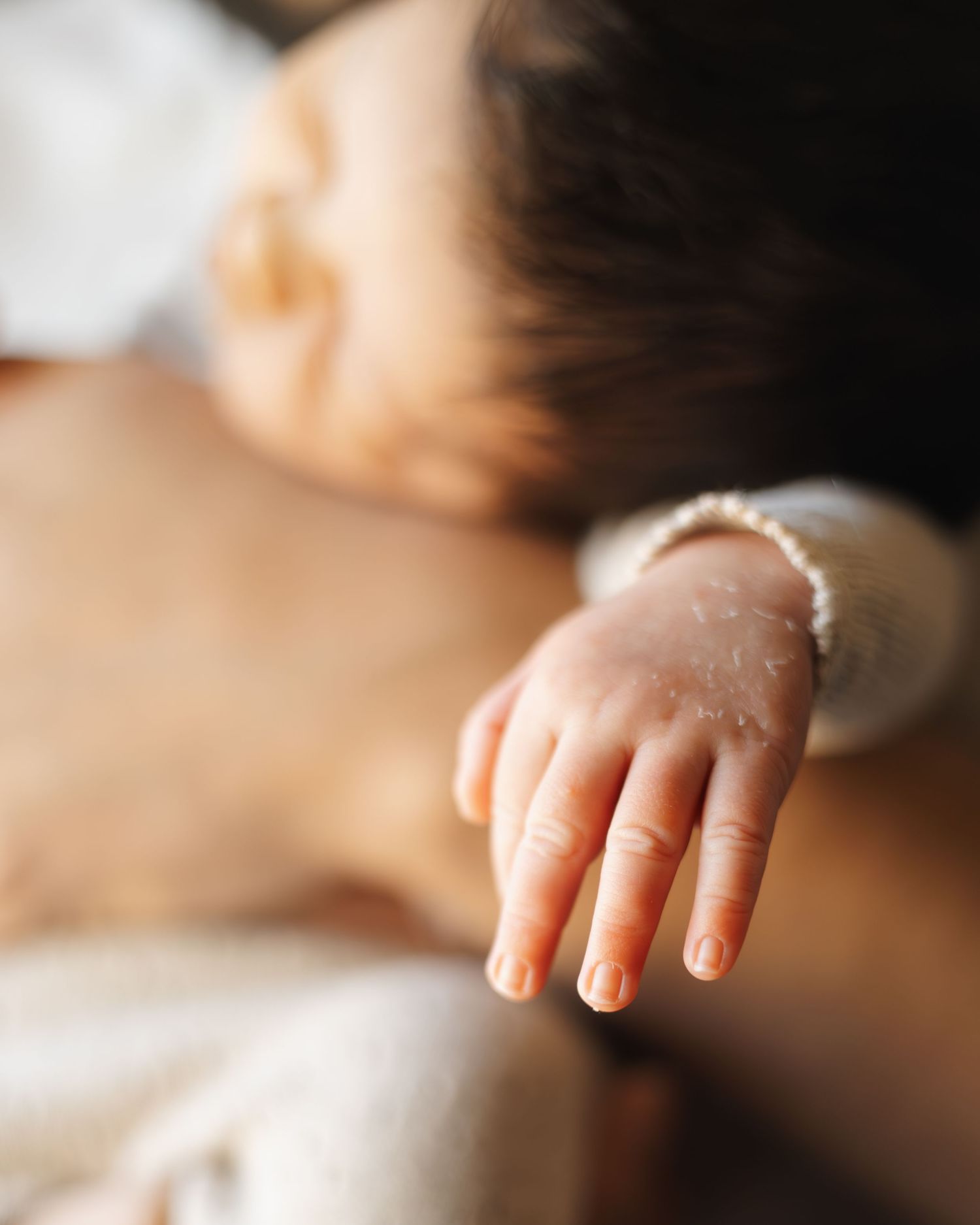 Artistic close-up of a baby's tiny hand in natural light.