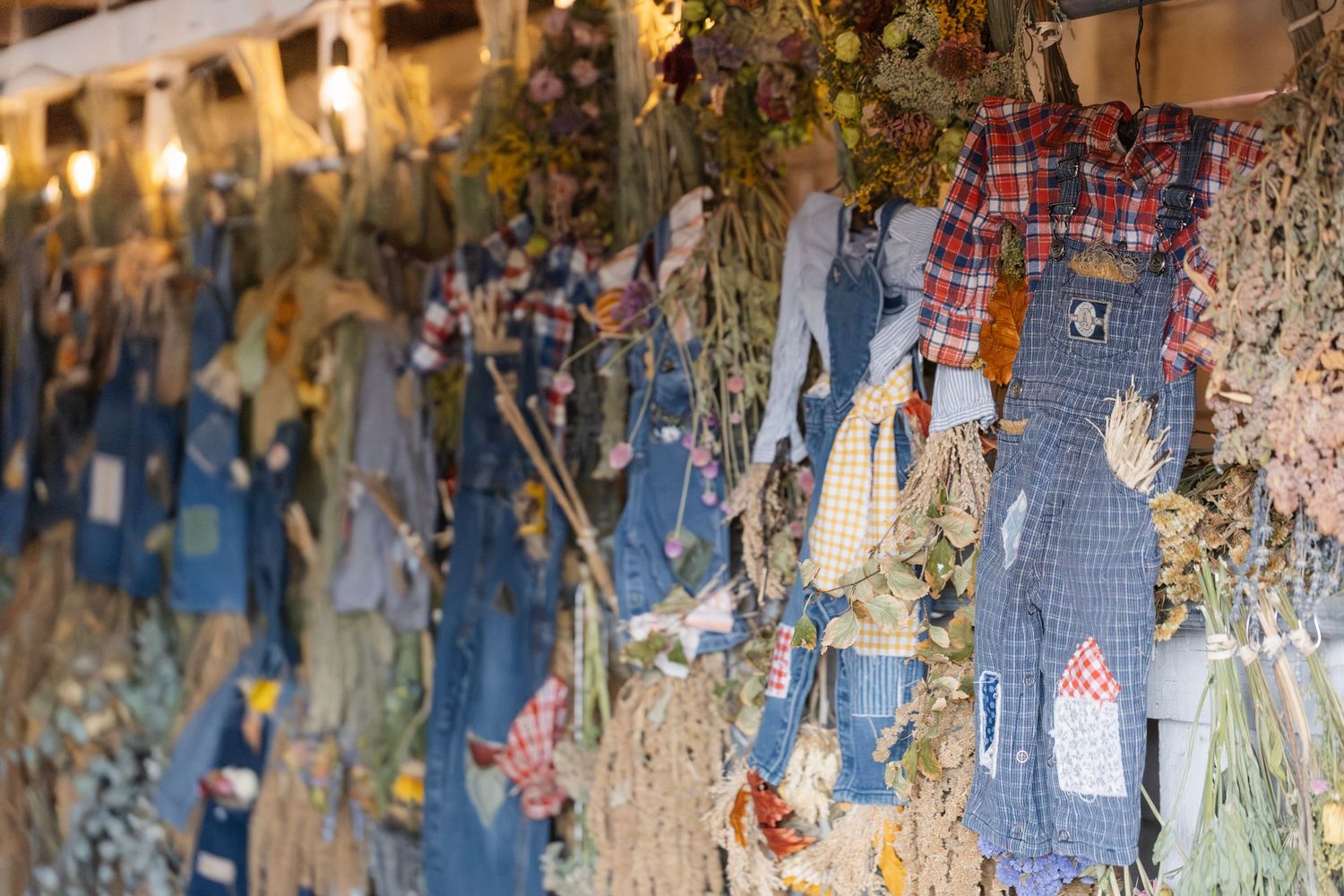 Decorative vintage-style fabric display with plaid and floral patterns hanging from above.