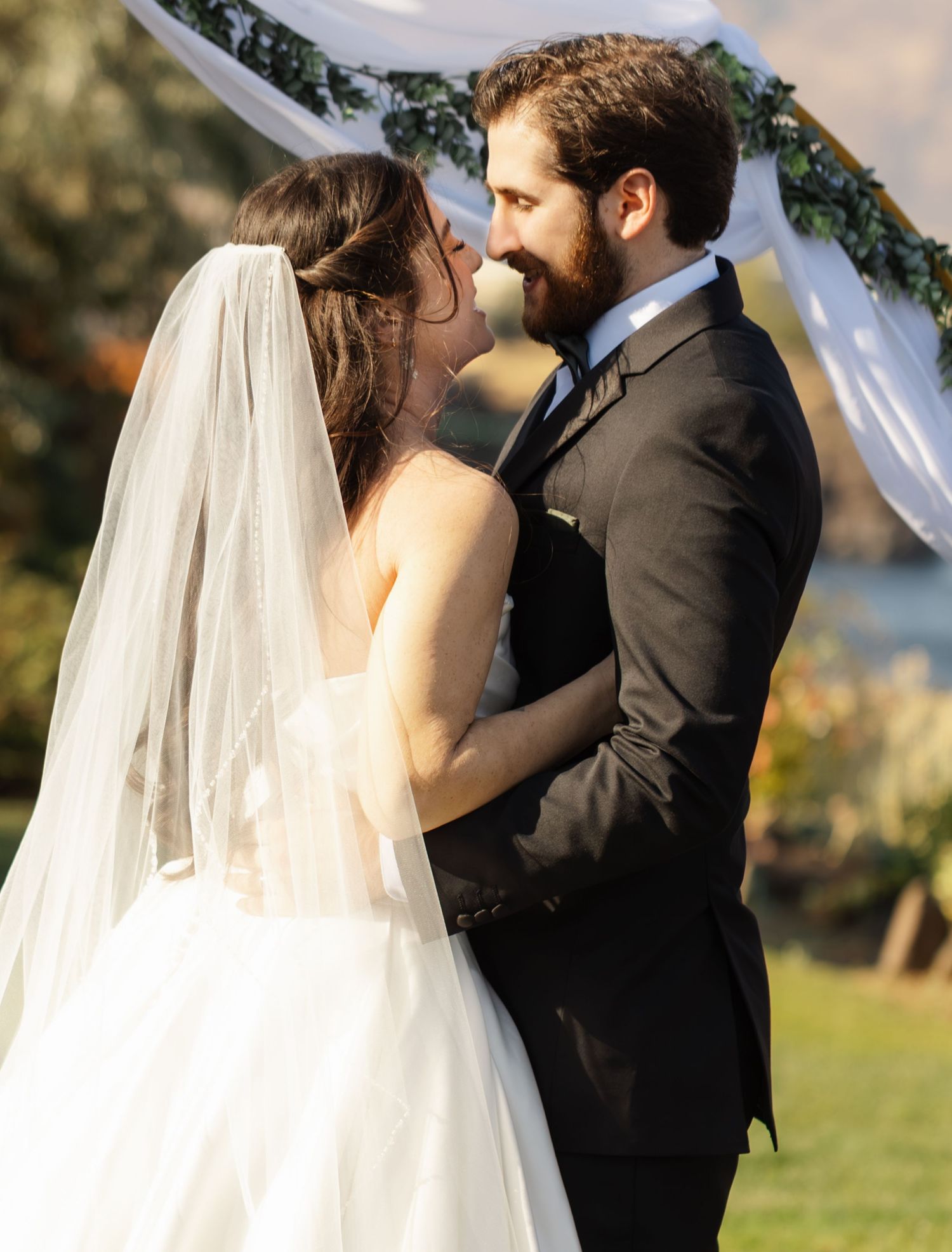 Outdoor wedding ceremony photos capturing intimate moments between newlyweds with scenic background.