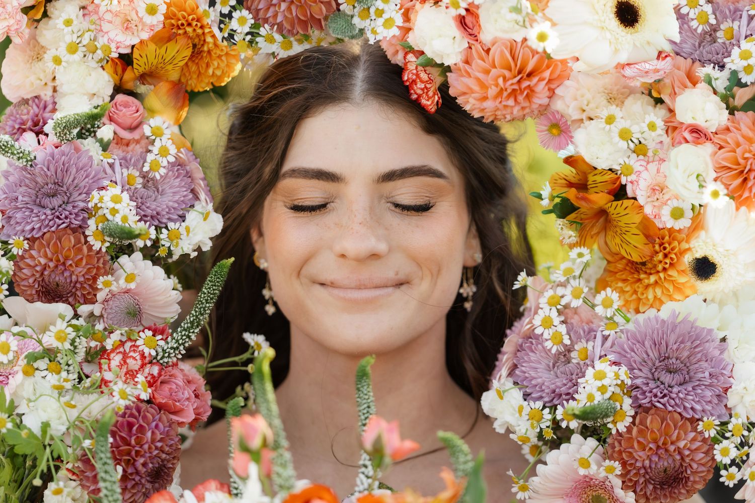 Colorful floral arrangements with pink, orange and purple blooms create a vibrant wedding backdrop.