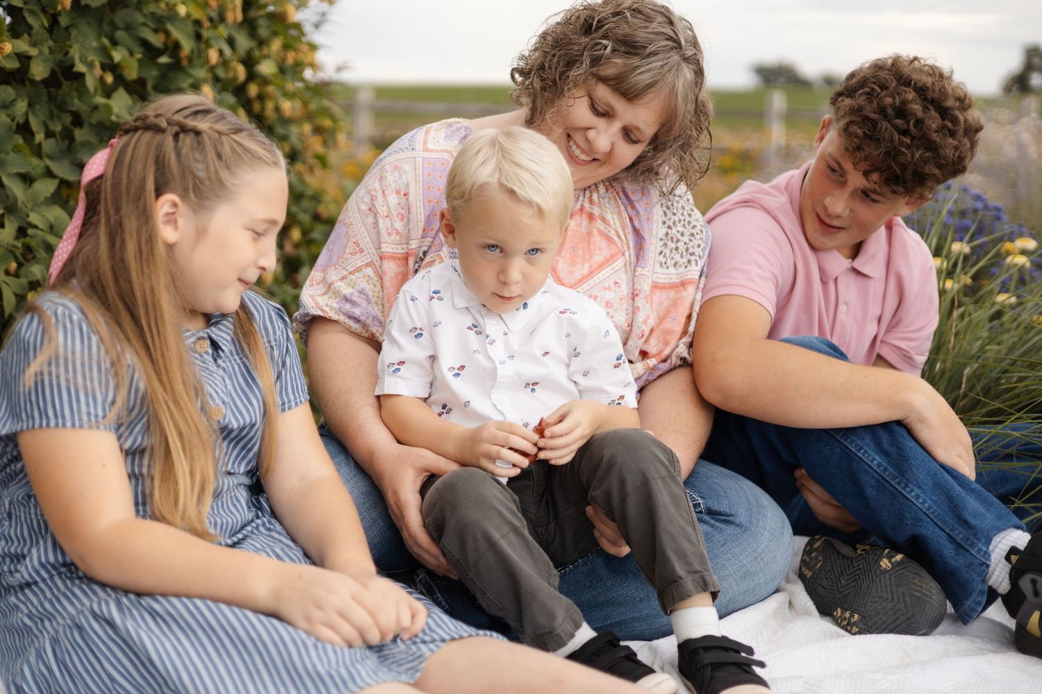 Group sitting together in a casual outdoor setting during golden hour.